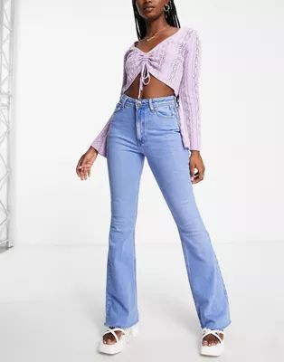 River Island raw hem flared jeans in mid blue | ASOS (Global)