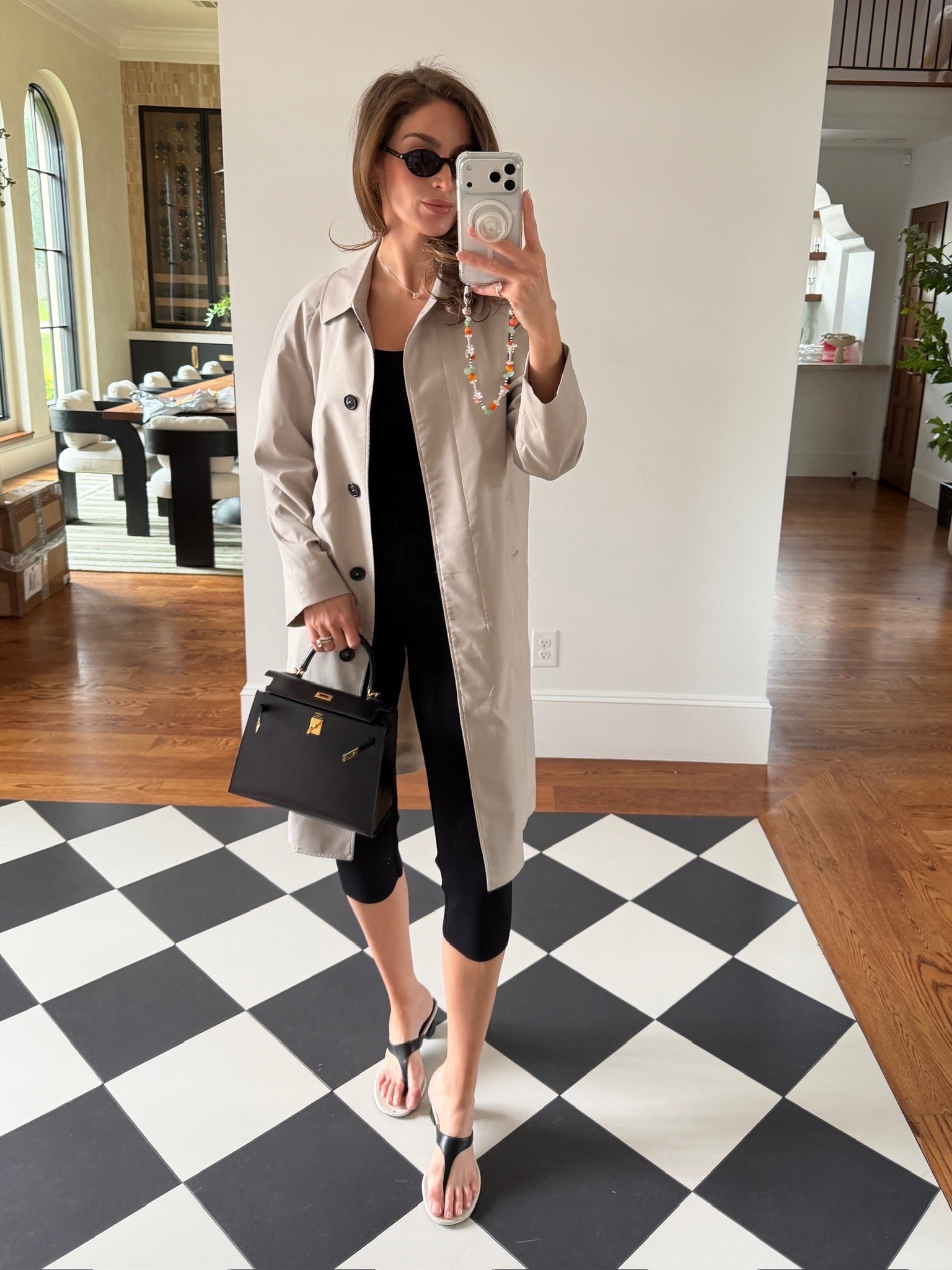 Custom trench by @thestudiomayfair. Black tank is from ALC Iris Fine Cotton Knit Tank.