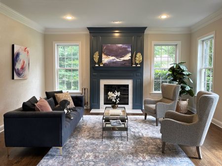 The Colorful Colonial’s  formal living room does not disappoint! Originally this fireplace was a dark wood tone and looked quite outdated but with a little paint and some vibrant artwork we were able to completely transform  the space! 
