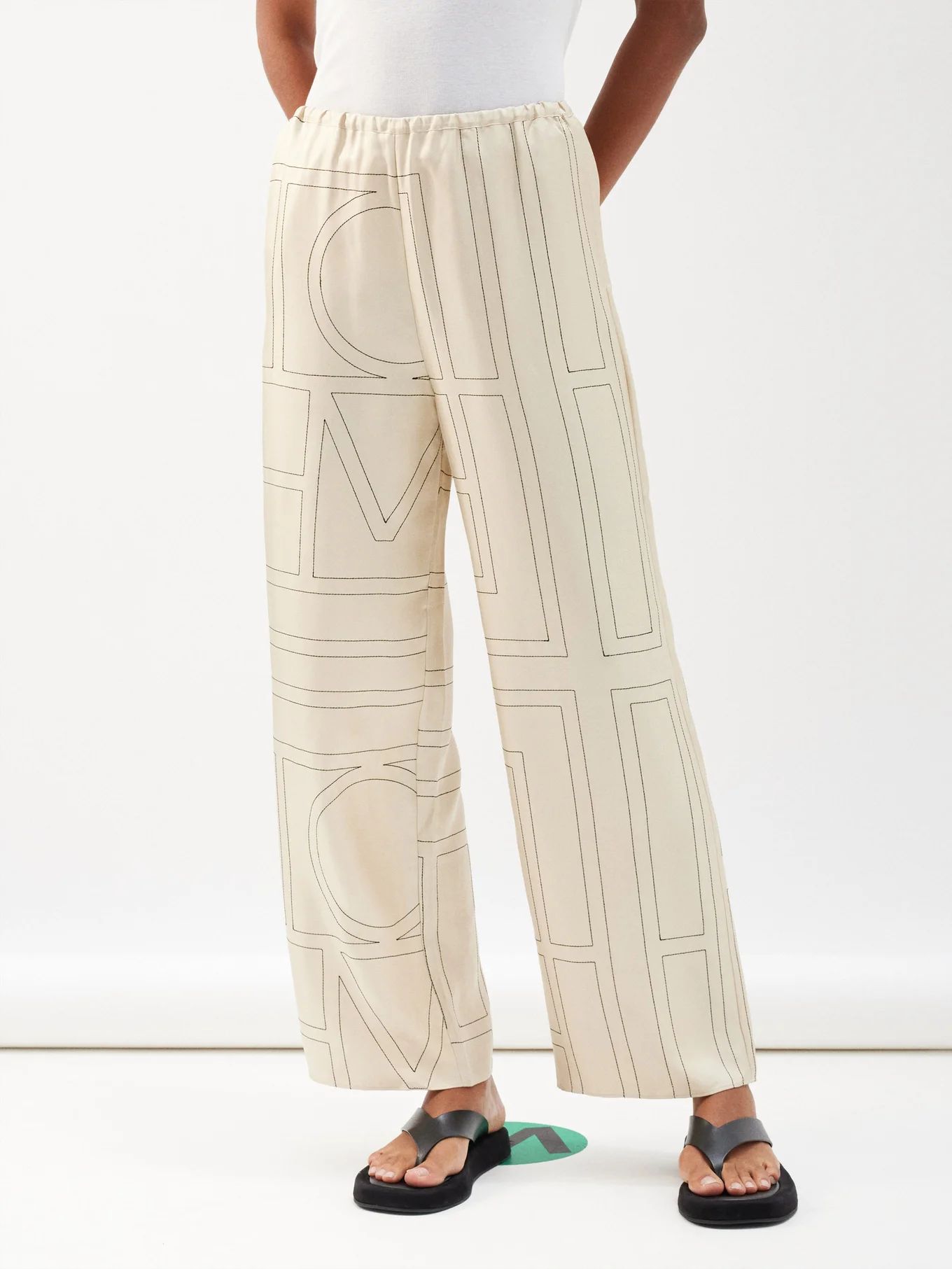 Monogram-embroidered silk-twill pyjama trousers | Toteme | Matches (US)