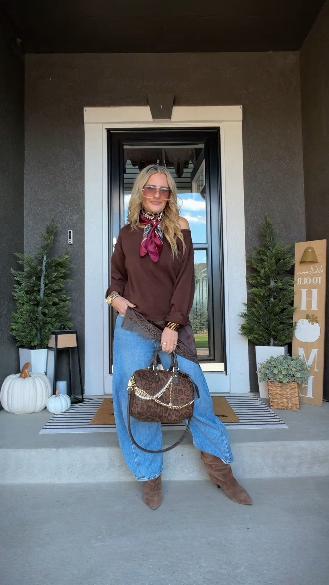 Fall outfit with blue barrel jeans, slouchy suede kitten-heel boots, and a brown sweater layered with a little lace underneath. The cheetah print bag, red scarf, and statement sunglasses add just enough personality to make an easy jeans-and-sweater outfit feel fun, current, and a little unexpected. 

 #LTKootd #LTKSeasonal #LTKOver40