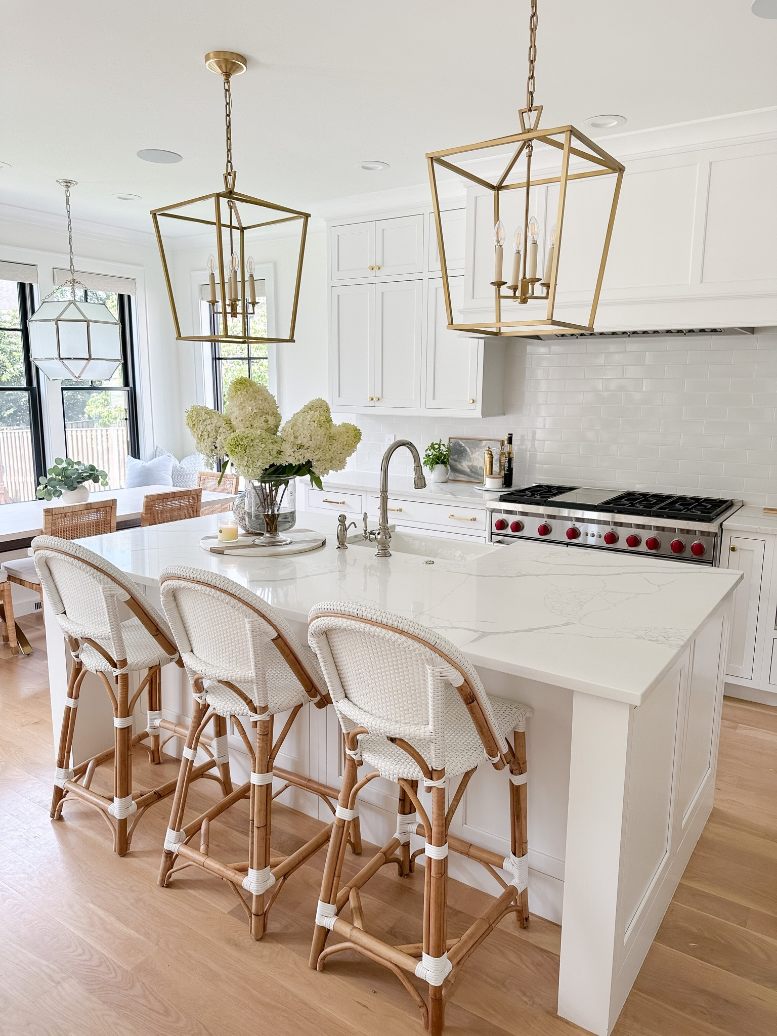White kitchen, coastal kitchen, counter stools, Serena & Lily Riviera Counter stools, bistro chairs, brass lanterns, island lighting, white subway tile, brass cabinet hardware 

#LTKhome #LTKstyletip #LTKsalealert