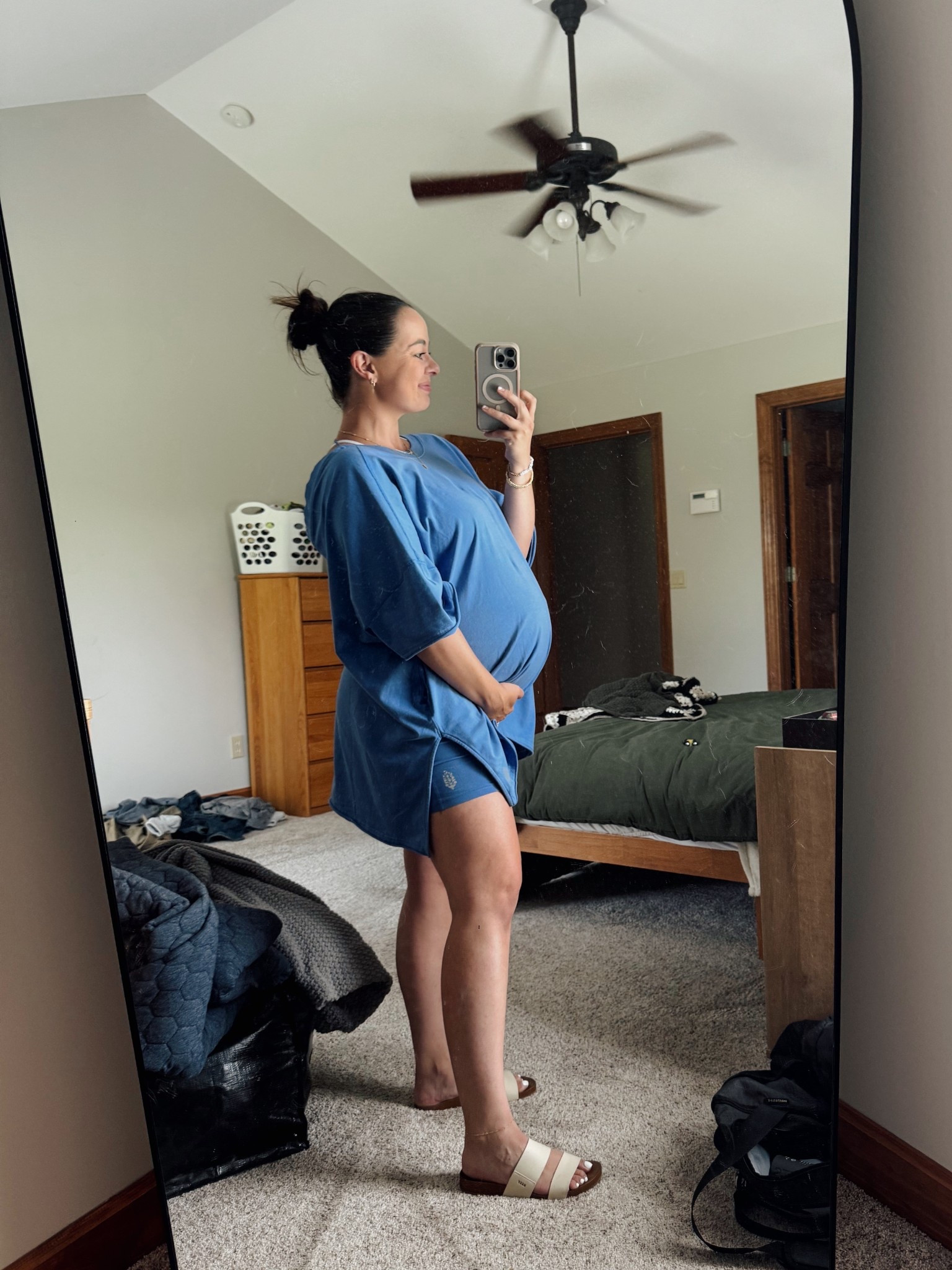 Definitely fits oversized! I’m wearing my true to size medium, at 37 weeks pregnant! 
