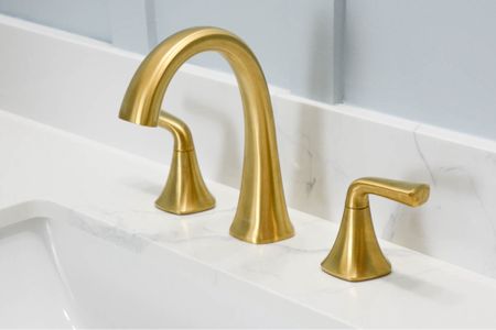 Loving our widespread bathroom faucet from Kohler. Gold bathroom faucets | brass bathroom faucet. Modern bathroom makeover with engineered marble top. 

#LTKhome