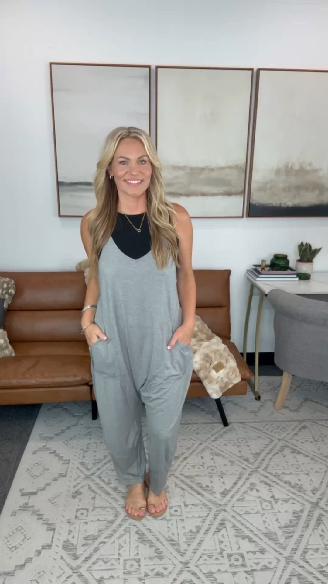 I changed into this after a long day because I wanted something that felt like loungewear but still looked cute enough to run errands. The fabric is lightweight and drapey, so it doesn’t cling, and layering it over a fitted tank gives it a little more shape while keeping it comfortable. Bonus points for the pockets because I always end up using them.

Gray jumpsuit, casual jumpsuit, layering outfit, black tank top, comfy everyday outfit, travel outfit, soft loungewear, relaxed fit jumpsuit, weekend style, boutique fashion, AudrieDollins

#LTKActive #LTKootd #LTKTravel