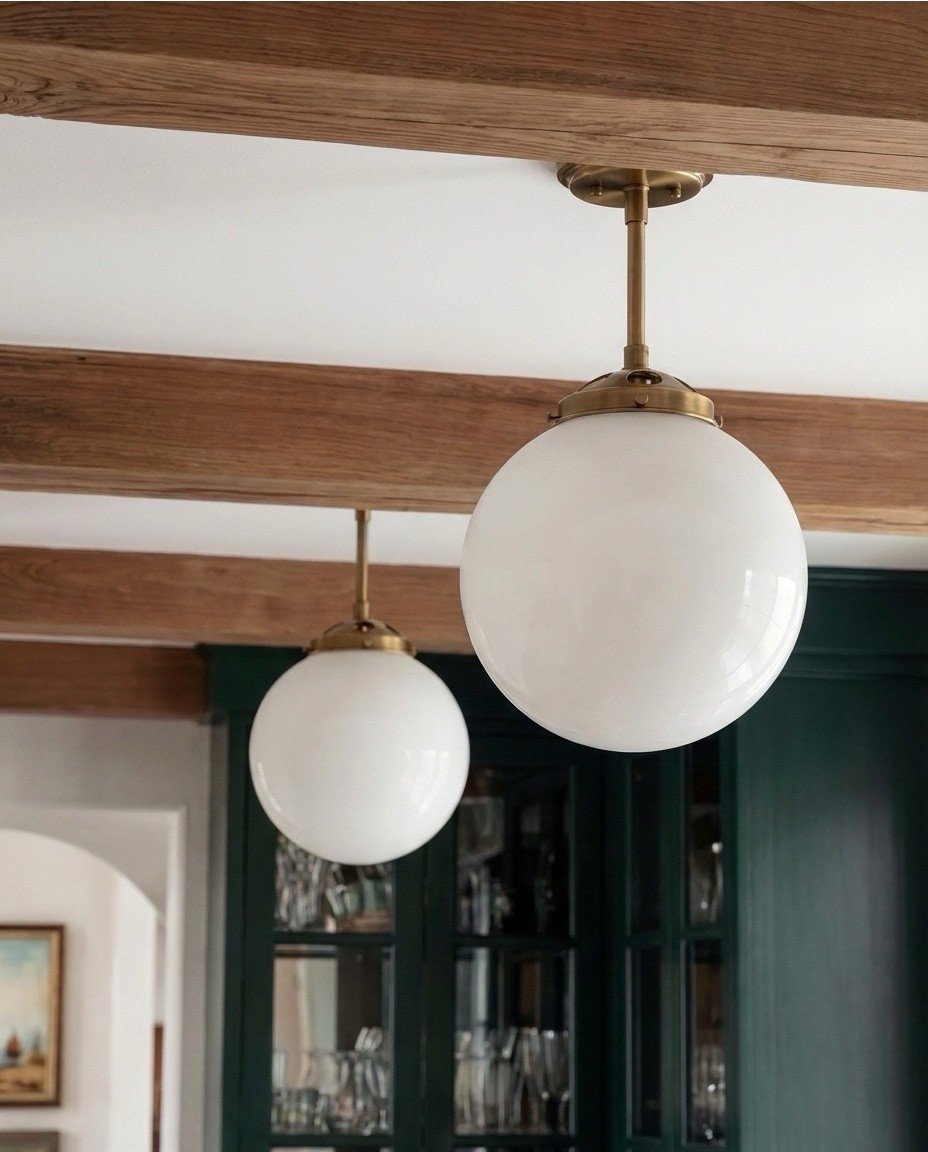 Shop the Look:
• Deep green paneled cabinetry
• Brass cabinet pulls + knobs
• Marble countertops (soft gray veining)
• Glass-front upper cabinets
• Built-in beverage/wine fridge
• Vintage-style runner rug (neutral tones)
• White globe pendant lights
• Exposed wood ceiling beams
• Open wood shelving
• Clear glassware set
• Ceramic vase with branches
• Countertop coffee machine
• Stoneware mugs + tray
• Light wood flooring
• Arched doorway with framed artwork
• coffee machine
• brass gold faucet 
• green vase
• letter bistro cup 
• globe pendant light 
Brass wall sconce 
Brass hand pulls

#LTKSaleAlert #LTKHome