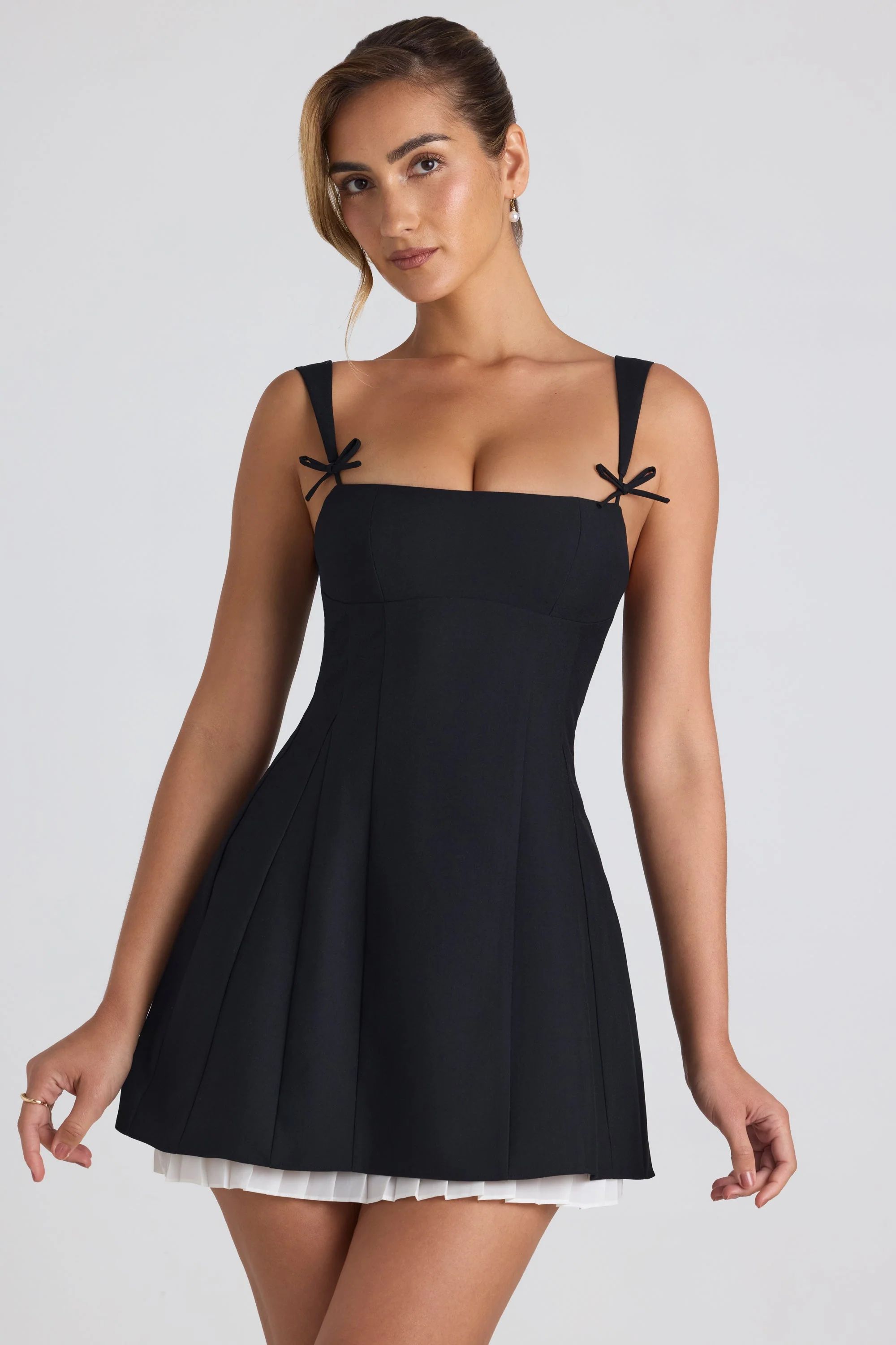 Bow-Embellished Pleated A-Line Mini Dress in Black | Oh Polly