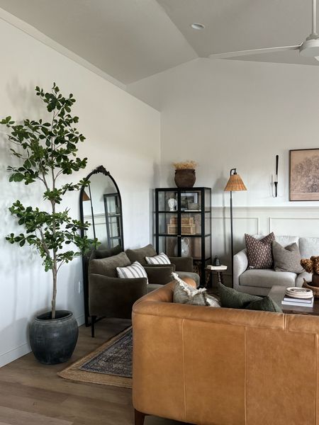 Faux black olive tree, shady lady tree, Amazon find, faux tree, budget friendly, Living room inspo, pinch pleat curtains, floor to ceiling curtains, neutral sofa, beige sofa, west elm penn chair, green accent chair, vintage pillows, Turkish pillows, shady lady tree, faux tree, greenery, Walmart floor lamp, woven table tray, square wooden coffee table, wall sconce, tapered candle holder, throw pillows, floor length mirror, arch mirror, Target home decor, affordable home, black cabinet, studio McGee cabinet, table,ltarget accent table, vintage inspired rug, vintage milking stool, foot stool


#LTKstyletip #LTKhome #LTKsalealert