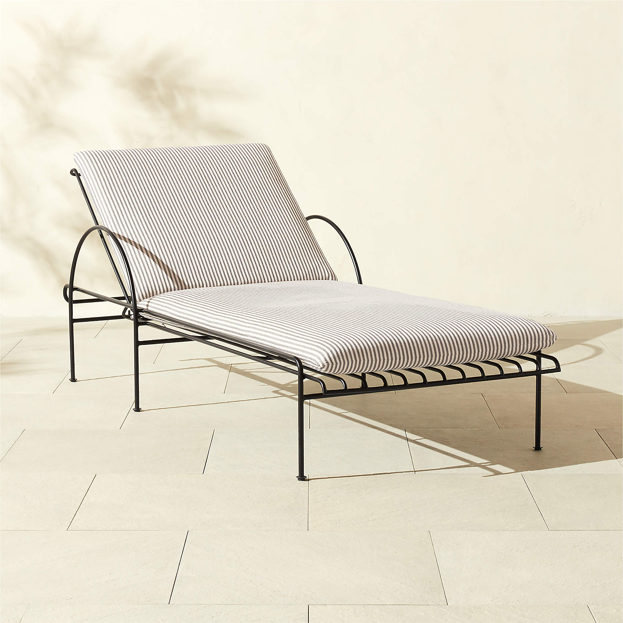 Costa Black Metal Outdoor Sun Lounger with Natural And White Striped Sunbrella Cushions | CB2 | CB2