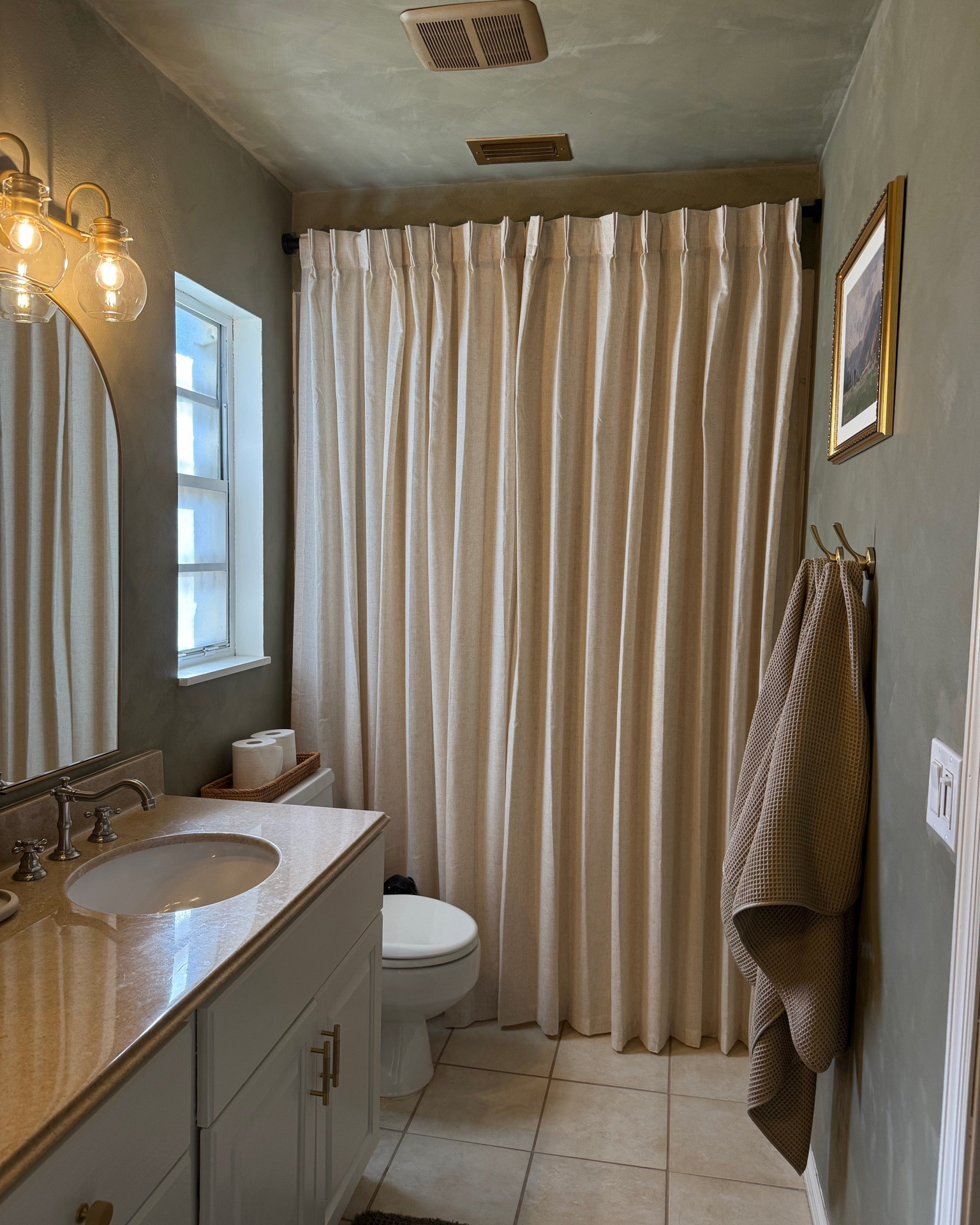 Our no-demo bathroom makeover 🤎 We gave this older bathroom a much-needed refresh without replacing the vanity, countertops or tile — just paint, working with what we already had, and making the finishes feel more intentional.

#LTKHome