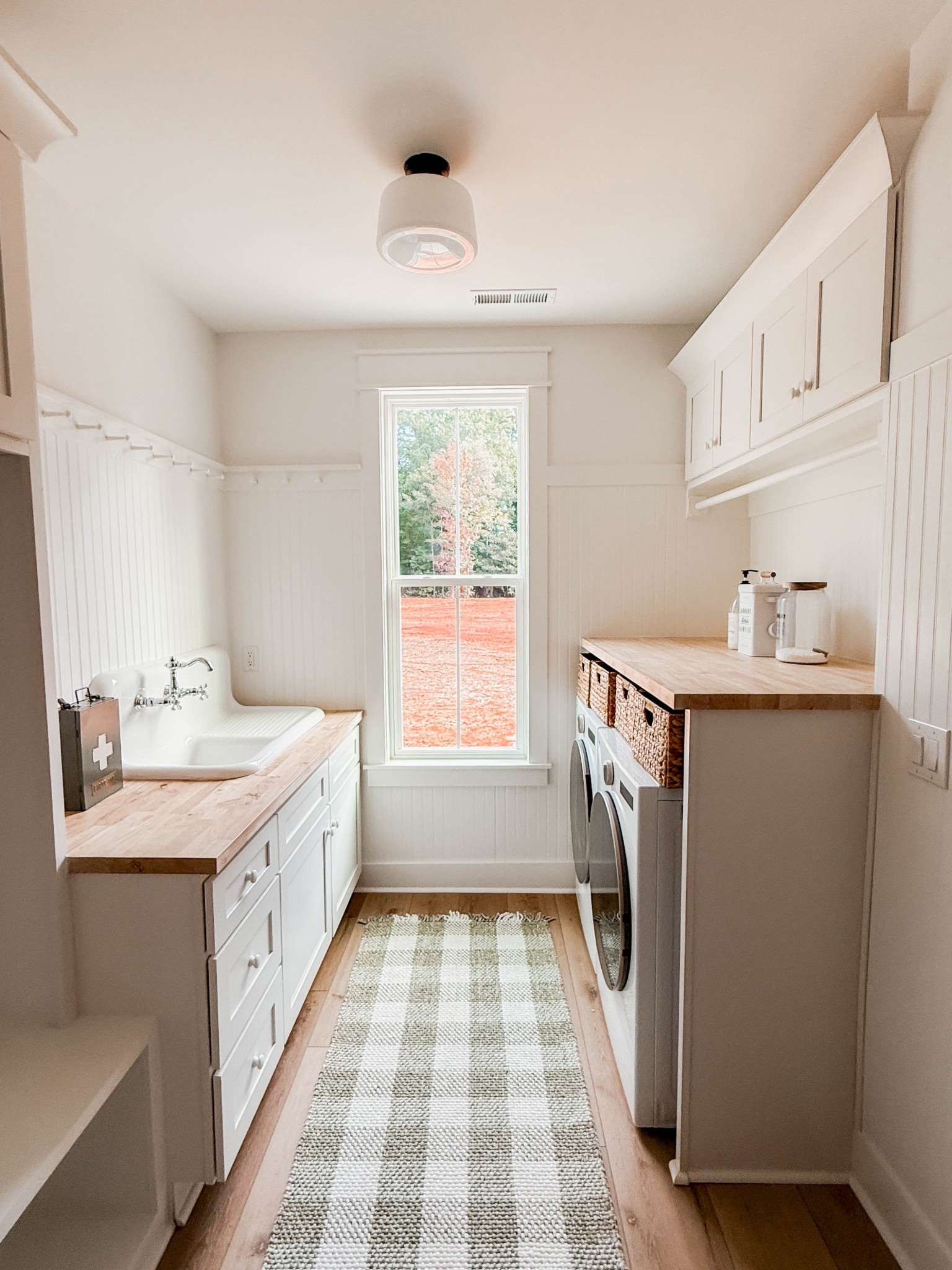 Vintage touches in the laundry room, and a gingham rug to pull it together. 
#ginghamrug #oldebricklighting #schoolhouselight #vintagesink #vintagefaucet #cottagefarmhouse #cottagelaundryroom #birchlane #vintagelighting

#LTKHome