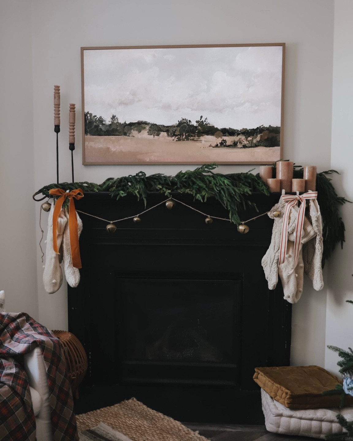 Knit stockings, copper velvet ribbon, red striped ribbon, totem candles, bell garland, brown and beige pillar candles, frame TV, mantel decorations, Christmas decor 

#LTKSeasonal #LTKHoliday #LTKhome