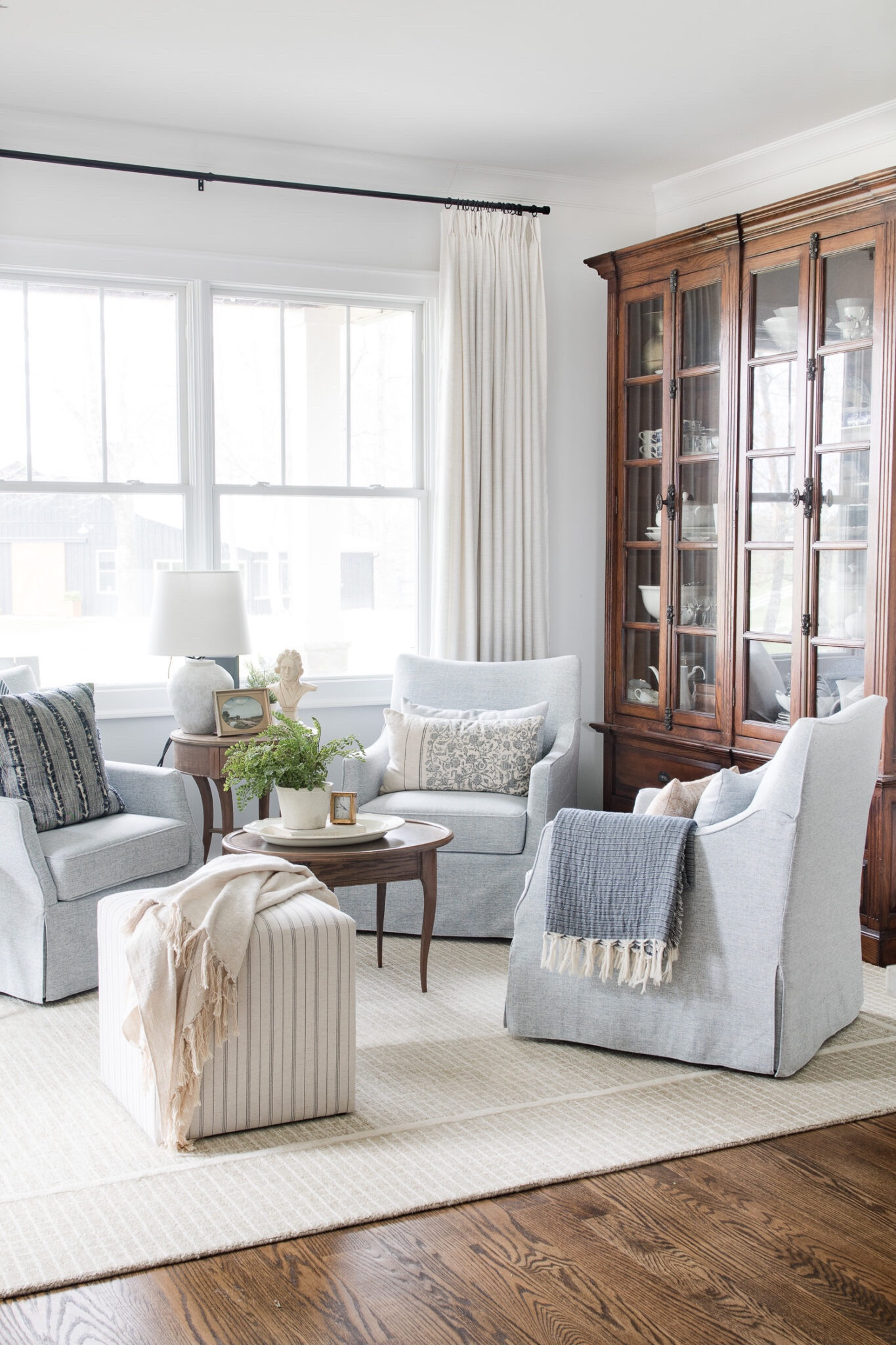 Sitting room with blue chairs, Loloi rug, wood bookcase and linen curtains 

#LTKSeasonal #LTKxPrimeDay #LTKHome