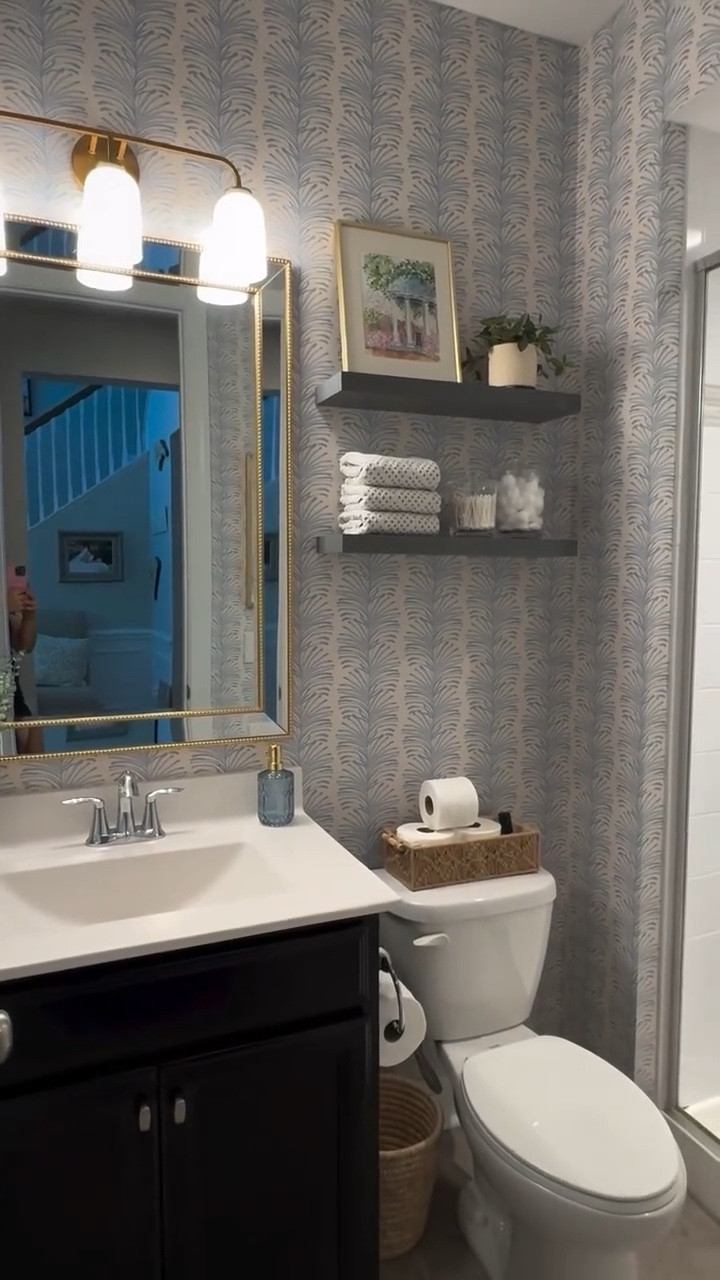 From builder grade to upgrade! ✨ 

We transformed this guest bathroom from a blank, basic space into a warm and personal retreat — complete with wallpaper, new lighting, custom shelving, and meaningful details.

Our client is a proud UNC Chapel Hill grad, so we used subtle nods to Carolina blue and added framed artwork featuring campus landmarks. Proof that a small space can still tell a big story.

Design tip: In guest bathrooms, don’t be afraid to go bold — it’s the perfect place to show personality.

#bathroomdesign #beforeandafterhome #guestbathroom #interiorstyling #smallspacedesign #bathroomremodel #wallpaperinspo #interiordetails #uncchapelhill #homedecorideas #organizedandstyled #modernbathroom #southernhome #pepperhome
