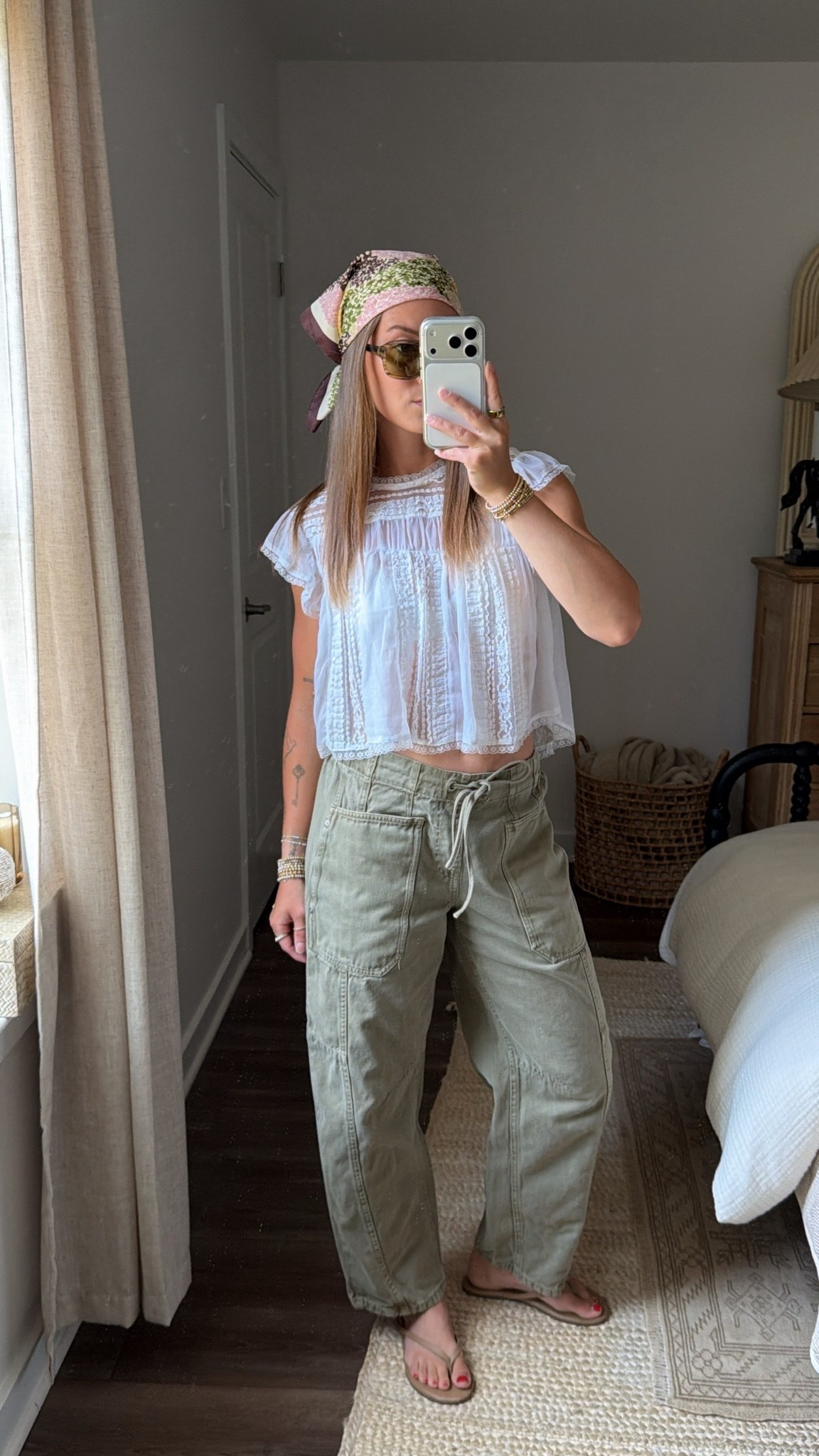 8/11/26 Summer-to-Fall Casual Outfit 🤎

Slowlyyyy starting to mix a little fall into my summer outfits. 🤎 Styled these olive green barrel pants with a feminine Free People lace top, Amazon bralette, my TKEES flip-flops I’ve worn nonstop all summer, Mango bandana, and J.Crew suede bag.

My pants were a TJ Maxx find from Scotch & Soda last year, so I sadly can’t link the exact pair, but I’ll link something similar! Sunglasses are VEHLA for reference. Such an easy, realistic transitional outfit that still works for these warmer August days. ✨

#LTKootd #LTKSeasonal