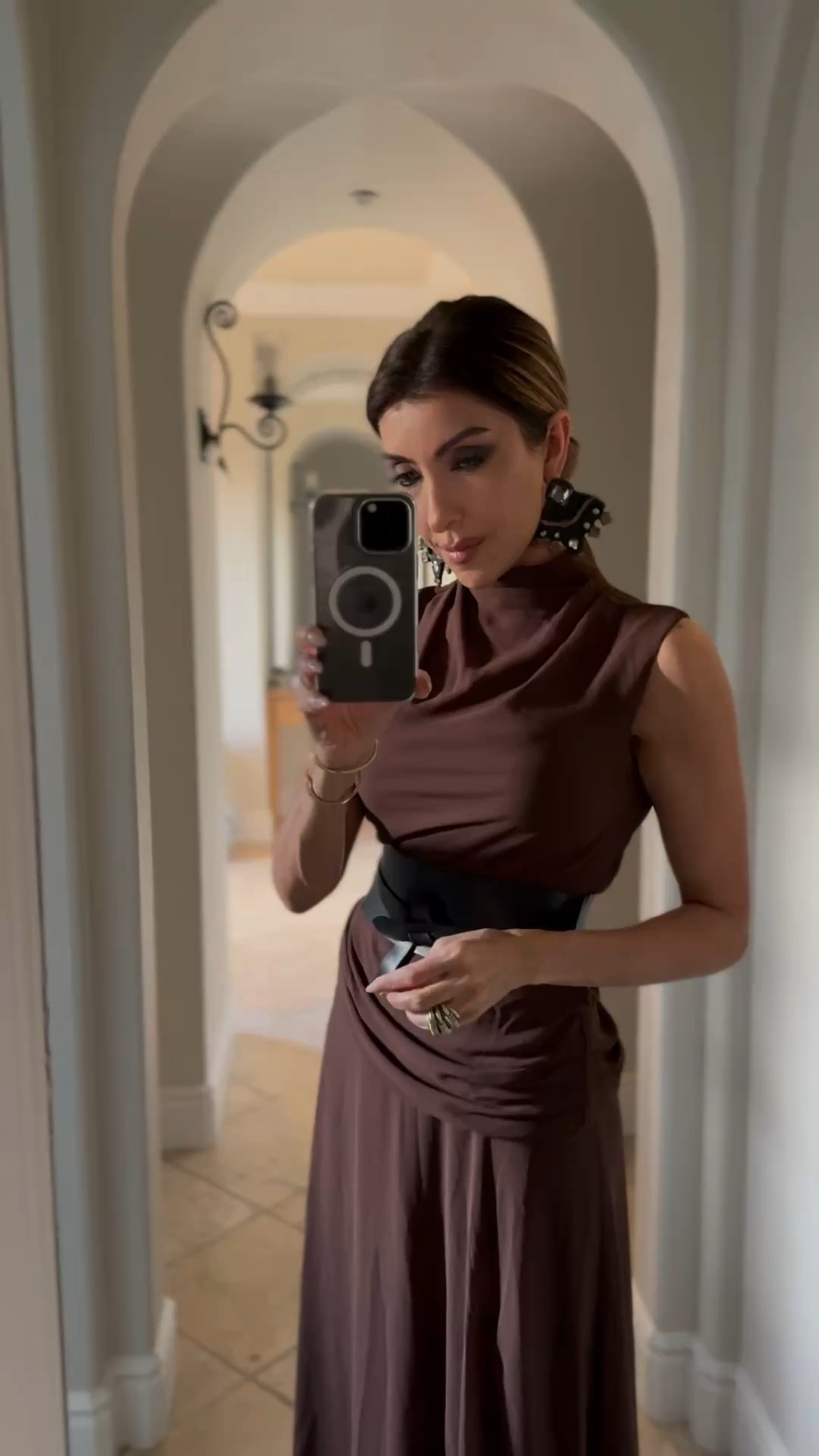 This chocolate brown maxi dress is a true wardrobe essential that effortlessly transitions from day to night. The mock neck and flowing silhouette create a timelessly elegant look, while the side slit adds just the right touch of allure. Style it casually with a leather jacket and boots for daytime adventures, or elevate it with heels and statement jewelry for evening events. The versatile design flatters every figure, especially when paired with a statement belt to define the waist. At this price point, this dress delivers exceptional value for the countless ways you'll style it. A perfect investment piece that will keep you reaching for it season after season. ✨​​​​​​​​​​​​​​​​

#LTKParties #LTKHoliday #LTKStyleTip