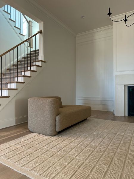 Boucle daybed, formal living room, neutral rug, ivory rug, chandelier, fireplace mantle, stone mantle 