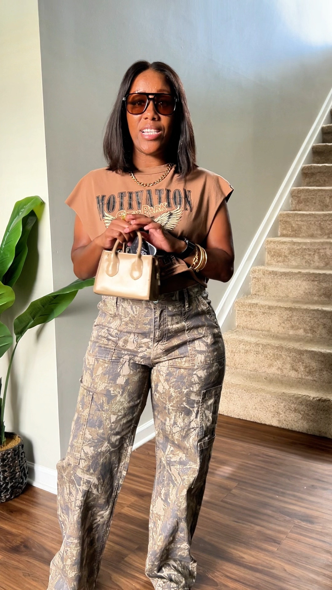 Casual outfit idea for going out to eat. I’m wearing a graphic tee crop top with wild camo cargo pants. I styled this outfit with sunglasses, brown purse, and Nike dunk low cacao wow. I accessorized with gold jewelry.

#LTKFindsUnder50 #LTKPetite #LTKStyleTip