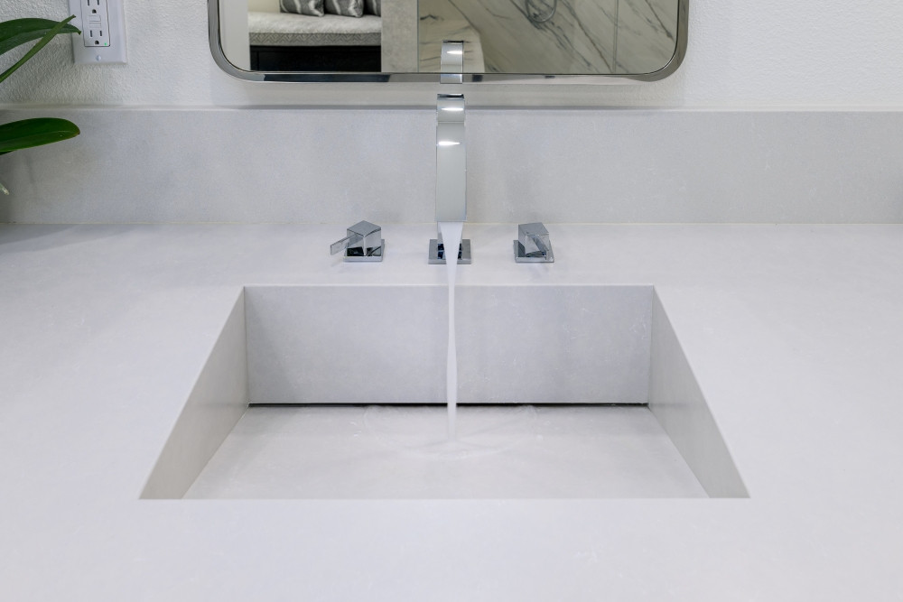 Modern. Minimal. Luxe. We designed and remodeled this bathroom with a custom quartz trough sink for a sleek, seamless look. The integrated design pairs perfectly with a wall-mounted faucet in polished chrome, keeping surfaces clean and elevated. It’s the kind of detail that transforms a vanity from basic to breathtaking—and proves that function and beauty go hand in hand.

Every element in your bathroom should feel intentional—and we’re here to design it that way.

#BathroomRemodel #CustomVanity #IntegratedSink #QuartzCountertop #WallMountedFaucet #MinimalistDesign #ModernBathroom #FunctionalLuxury #DesignBuildFirm #LTKHome #PinterestBathroom #InteriorDesignInspo #LuxuryVanity #CleanLines #SpaStyleAtHome #RemodelReveal 

 #LTKHome