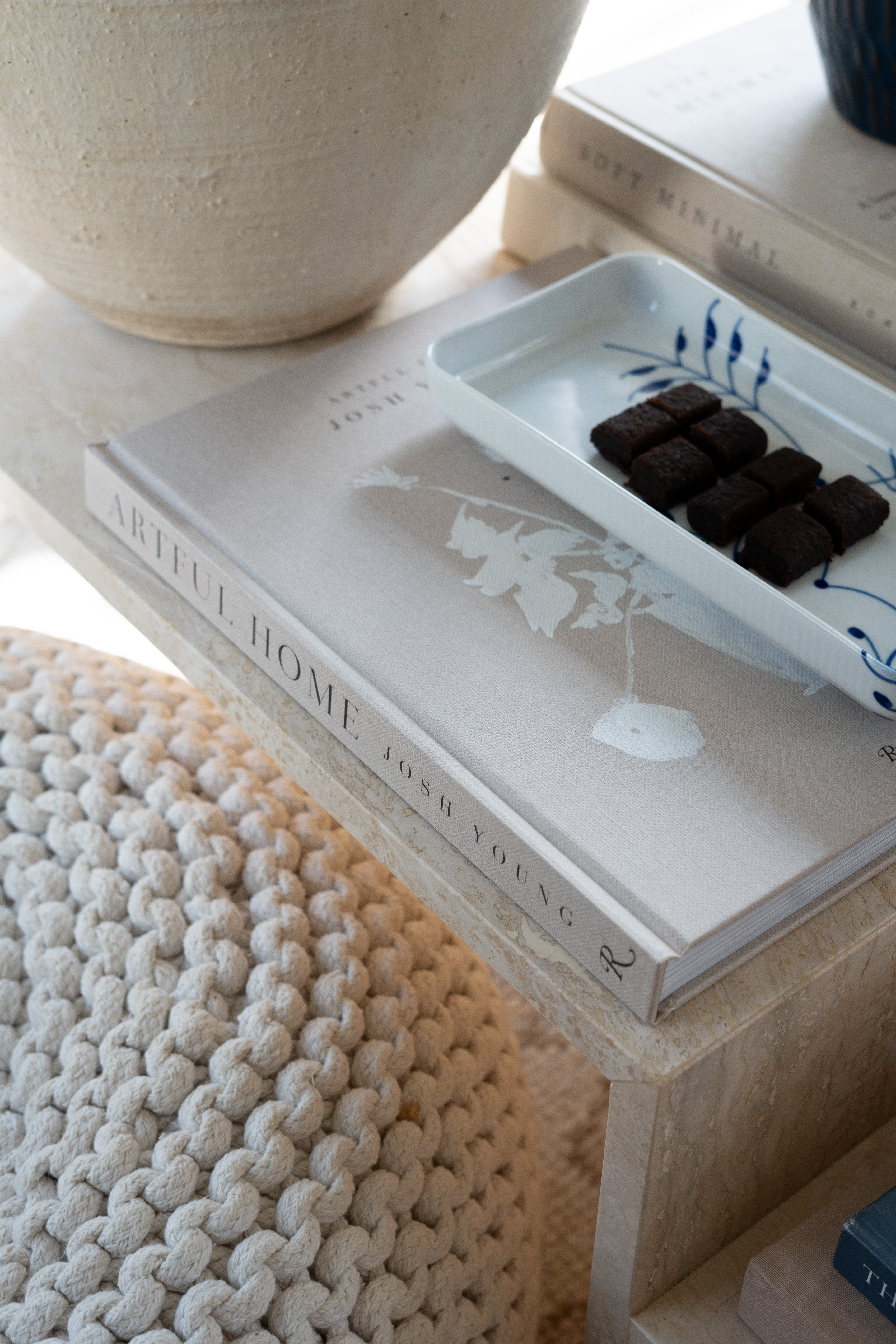 I cannot get over how dreamy this little setup is. The marble coffee table styling, stacked interior design books, cozy knit textures, and the tiny snack tray feel like the perfect slow afternoon at home. Neutral living room decor done right. 

 #LTKSpringSale #LTKfoodie #LTKHome