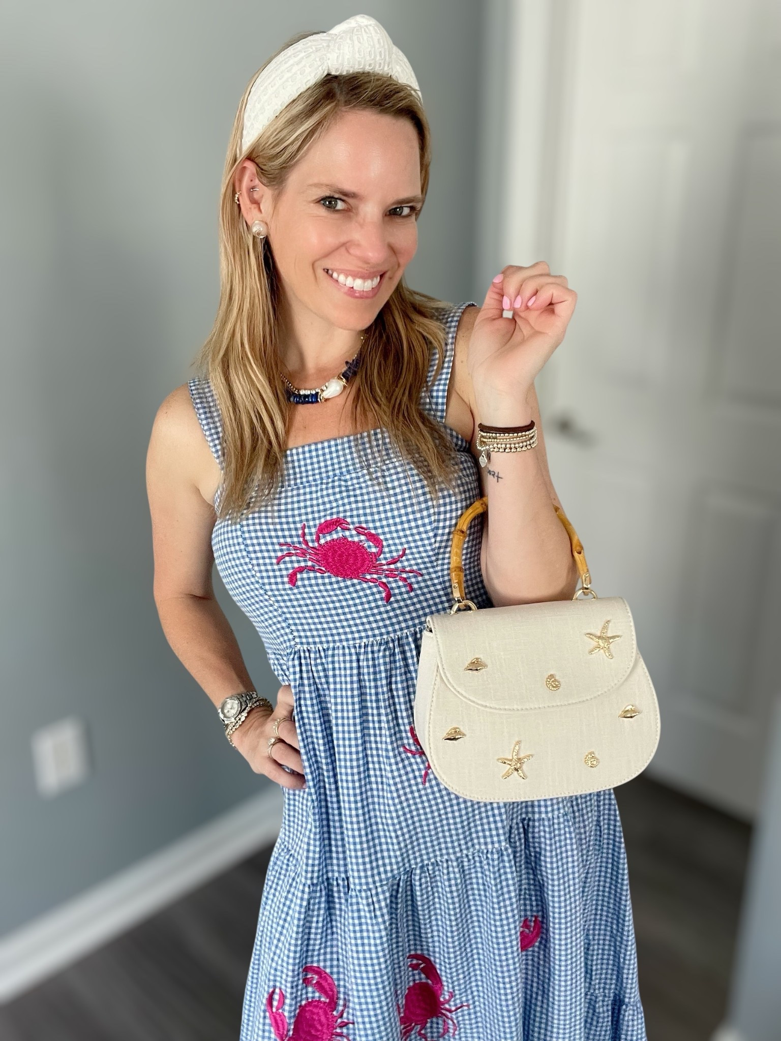 🦀 Dress is size XS | Headband & bag are Amazon finds 💙🤍

Nothing says coastal summer like a breezy blue gingham maxi with embroidered pink crabs 🦀💗 This tiered dress is light, flowy, and full of personality—perfect for seaside strolls, summer parties, or a crab boil on the porch! 🐚🍉 I paired it with a classic ivory textured knot headband and a darling mini top-handle bag featuring gold sea-inspired embellishments 🌟🐚

✨ Accessories:
	•	Headband: textured ivory twist style 👑
	•	Bag: cream mini satchel with starfish & shell accents 👜
	•	Jewelry: coastal-inspired statement necklace + Melinda Maria favorites (use code PREPPYREBEL for 10% off!) 💎🌊

📸 A perfect preppy pick for beach towns, nautical getaways, or backyard barbecues with a touch of whimsy 💙


#LTKPetite #LTKItBag #LTKFindsUnder50