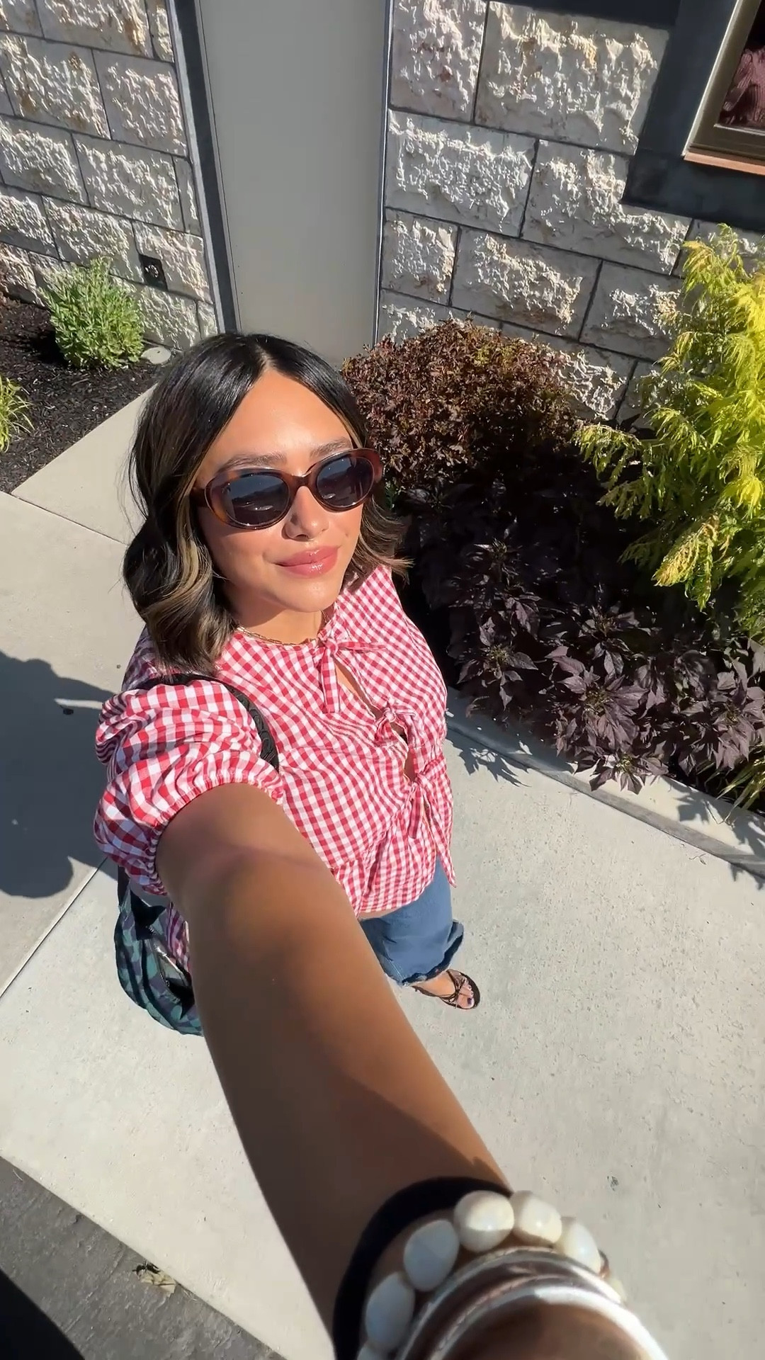 the cutest red gingham tie up top from amazon! i’m wearing a size XL and am  31 weeks pregnant - 220lbs and 5’6!! styled with jeans and black  seychelles flip flops