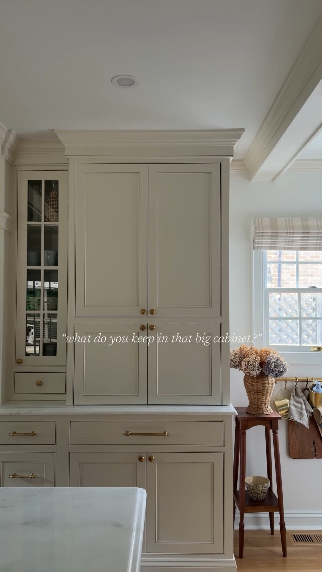 One thing we intentionally designed the kitchen around was having one hard-working cabinet that could hold the real life appliances we use constantly without taking over the counters.

The lower pull-outs house our larger everyday coffee maker and air fryer, so they’re easy to use, easy to tuck away, and don’t require rearranging the entire kitchen to use them.

Above, we keep all of the smaller appliances and gadgets in one dedicated spot: the KitchenAid mixer, blender, hand mixers, random attachments, and all the little things that somehow multiply over time.

It’s one of those behind-the-scenes decisions that has made the kitchen function so much better day to day while still keeping everything feeling calm and uncluttered.

If you’re looking for other kitchen details and sources, comment SHOP and I’ll send everything over!