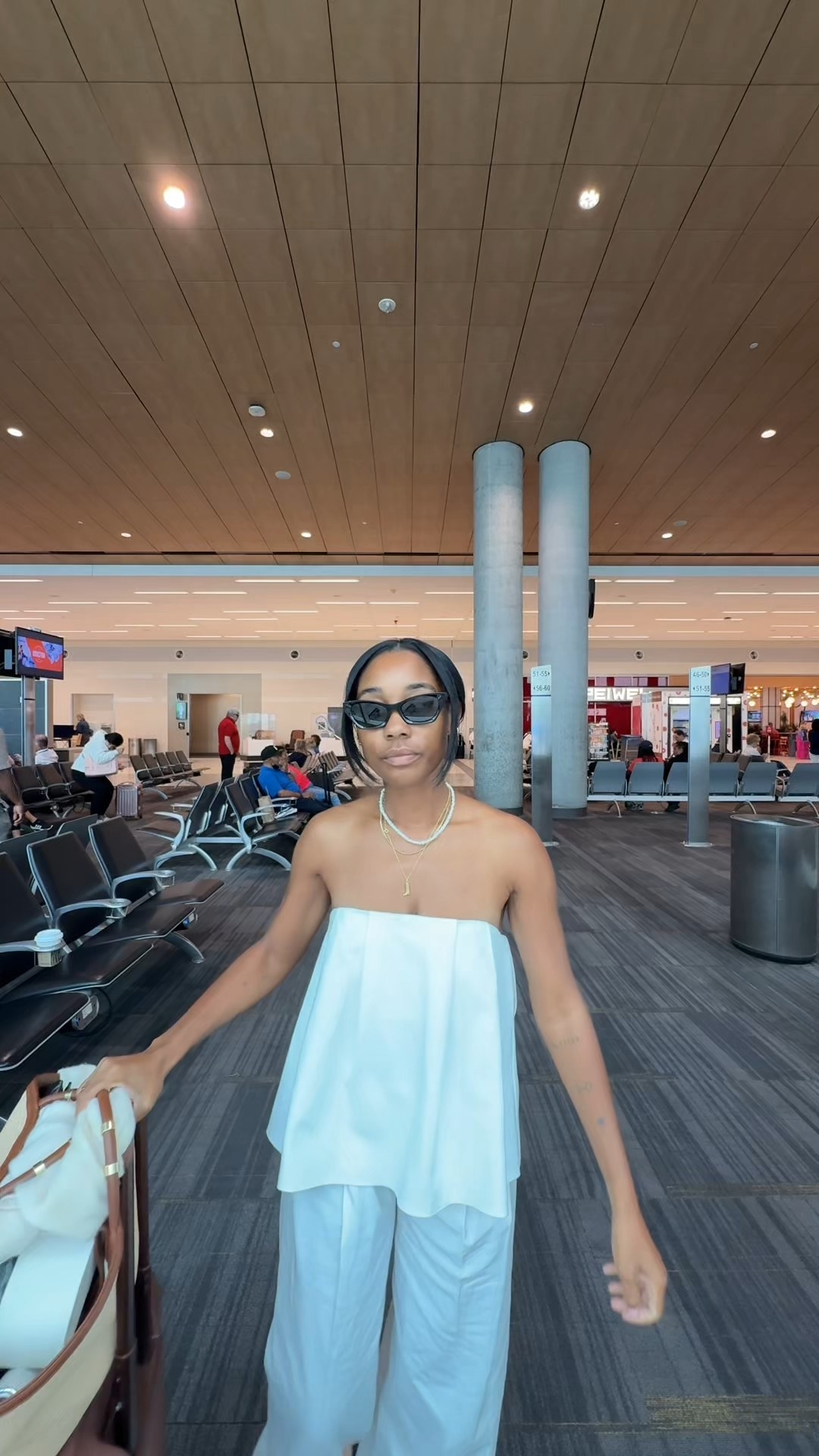 Today's travel outfit - white strapless top and linen white pants - raffia tote and Beis carry on suitcase luggage 

#LTKTravel #LTKStyleTip #LTKItBag