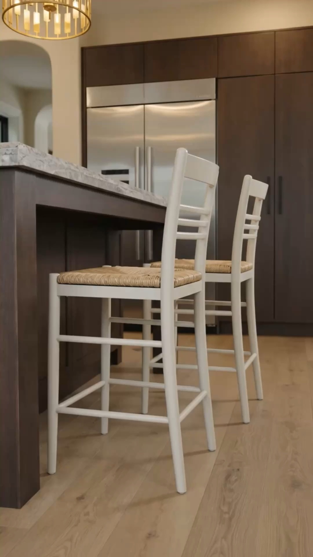 Kitchen island refresh for summer ✨

A few simple swaps can completely transform the heart of your home. Replacing traditional barstools with these cream-toned woven counter stools instantly creates a lighter, more relaxed feel.

The combination of rich dark cabinetry, warm white oak flooring, and natural seagrass brings that effortless coastal chic vibe—sleek, timeless, and full of charm.

I’m loving this soft color palette: creamy whites, natural textures, and deep wood tones that feel fresh for summer while staying classic year-round.

Save this look if you’re planning a kitchen refresh this season.

#KitchenIsland #KitchenRefresh #CoastalChic #SummerDecor #BarstoolStyle #KitchenDesign #WhiteOakFlooring #CoastalModern #ModernClassic #NeutralHome #HomeDecor #InteriorDesign #KitchenInspiration #Seagrass #CounterStools #TimelessDesign #LTKHome #KitchenGoals

#LTKdayinmylife #LTKHome #LTKSaleAlert