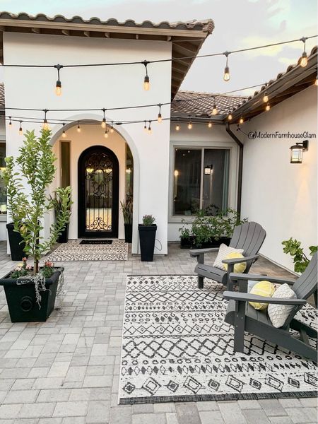 Courtyard at Modern Farmhouse Glam. 
Patio furniture outdoor rug Adirondack chair lights planters spring summer 

#LTKhome