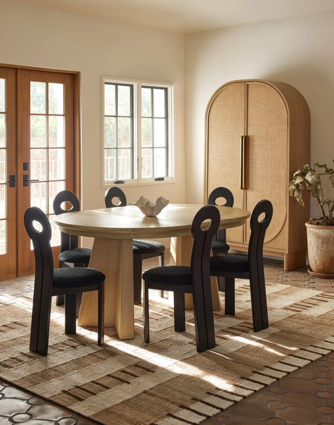 Suzette Cabinet : Keep it timeless for a look that's always fresh with Suzette. The collection's rounded oak frames feature grasscloth paneling for a soft, airy feel full of natural texture appeal. With soft-close doors, this cabinet offers plenty of storage for all those linens, dishes, barware, or loose ends that make your home complete.

Details: 
Number Of Cabinet Doors: 2
Cabinet Door Closure Type: Soft close
Number Of Shelves: 4
Material: Oak Wood, Oak Veneer, Grasscloth
Shelf Removable: 2 Yes, 2 No
Imported
Wood is a natural material—subtle variations in grain and tone reflect its organic character.

Dimensions 

Overall Dimensions: 43"W x 17"D x 78.5"H
Product Weight: 251 lbs
Weight Capacity: 70 lbs per shelf
Shelf Dimensions: 41"W x 14"D x 0.75"H
Interior Storage Dimensions: 41"W x 14.25"D x 69.5"H
Shelf Clearance: 12.5"
Leg Height: 7"

#LTKHome