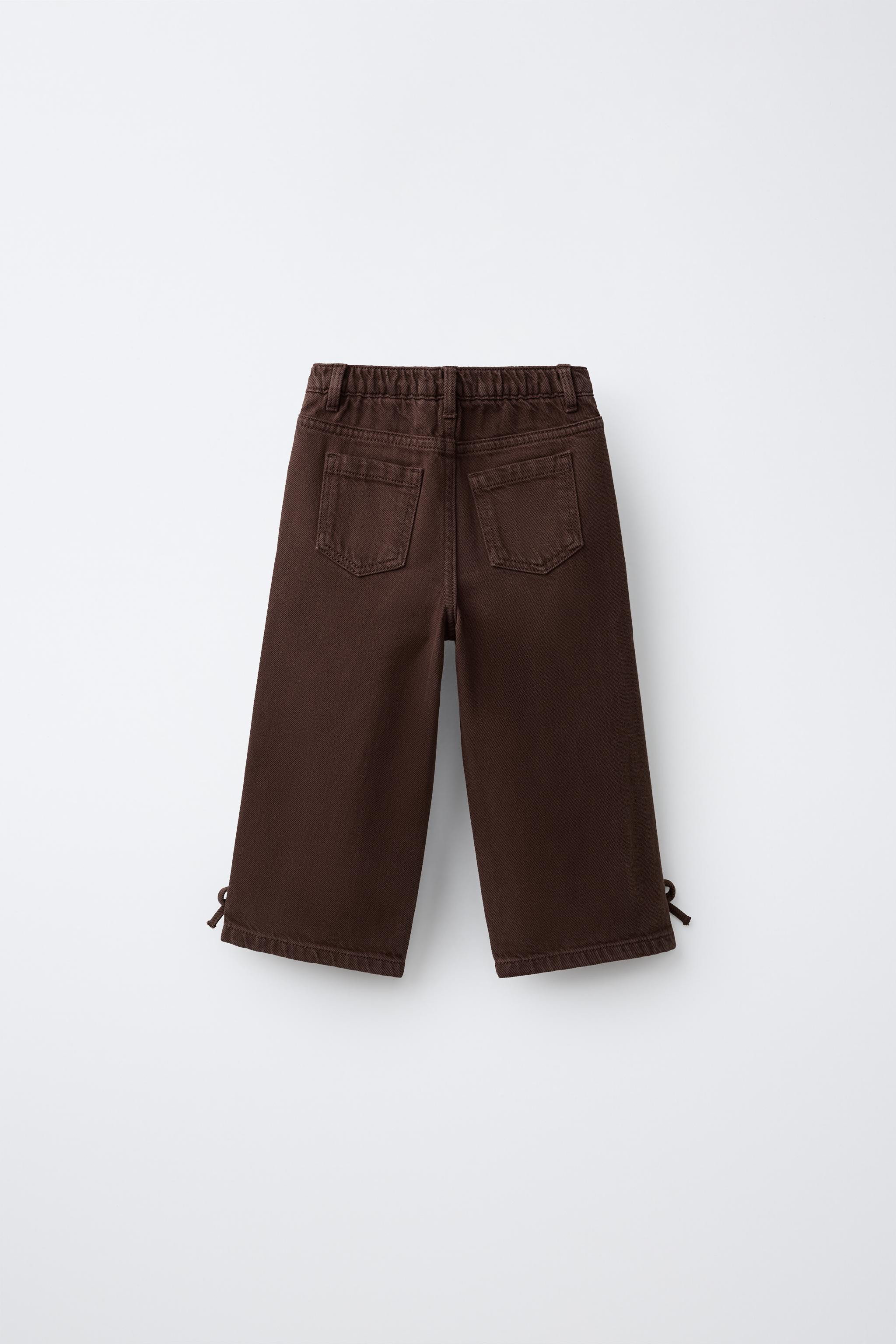 Wide leg jeans with an elastic waistband and front snap-button closure. Front pockets and patch p... | Zara US