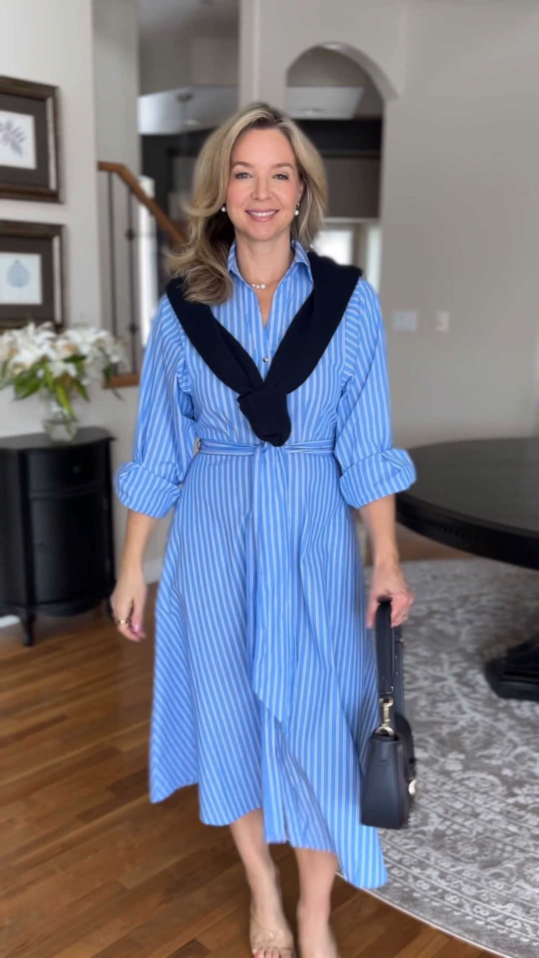 There is nothing I love more than a classic shirt dress. This one has a spring feel to it and works for a  budget conscious shopper. This H&M find is a true wardrobe staple—it’s a timeless silhouette that works for the office, weekend brunch, or a casual dinner.
The secret to making affordable fashion look high-end is all in the styling:
The Structured Collar: Instantly adds a crisp, professional feel.
The Sleeve Roll: Makes the midi dress feel relaxed and lived-in.
The Navy Layer: Draping a knit sweater over the shoulders adds the perfect amount of dimension.
Fabric Note: This blue version is 100% cotton, which gives it that beautiful, structured shape. It does come in two other colors, but keep in mind those are a 100% viscose blend if you’re looking for a softer drape! The fabric is pretty thin so I will wear a half slip likely just for peace of mind!
Whether you style it with a handheld bag or as a crossbody, this dress is proof you don’t need a designer budget to build a capsule wardrobe.


#LTKgrwm #LTKOver40 #LTKPetite