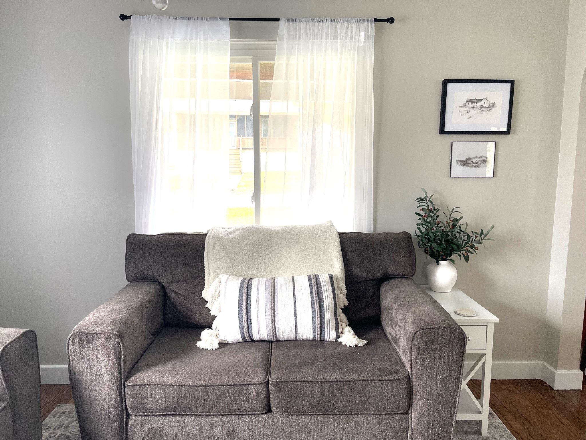 Some of my living room favorites! 
Living room decor, gray and white home decor, cottage decor, vintage home, home decor, Amazon home decor, faux olive branches, neutral throw pillows, white end tables, gray couch, sheer curtains 

#LTKhome #LTKfindsunder50 #LTKfindsunder100
