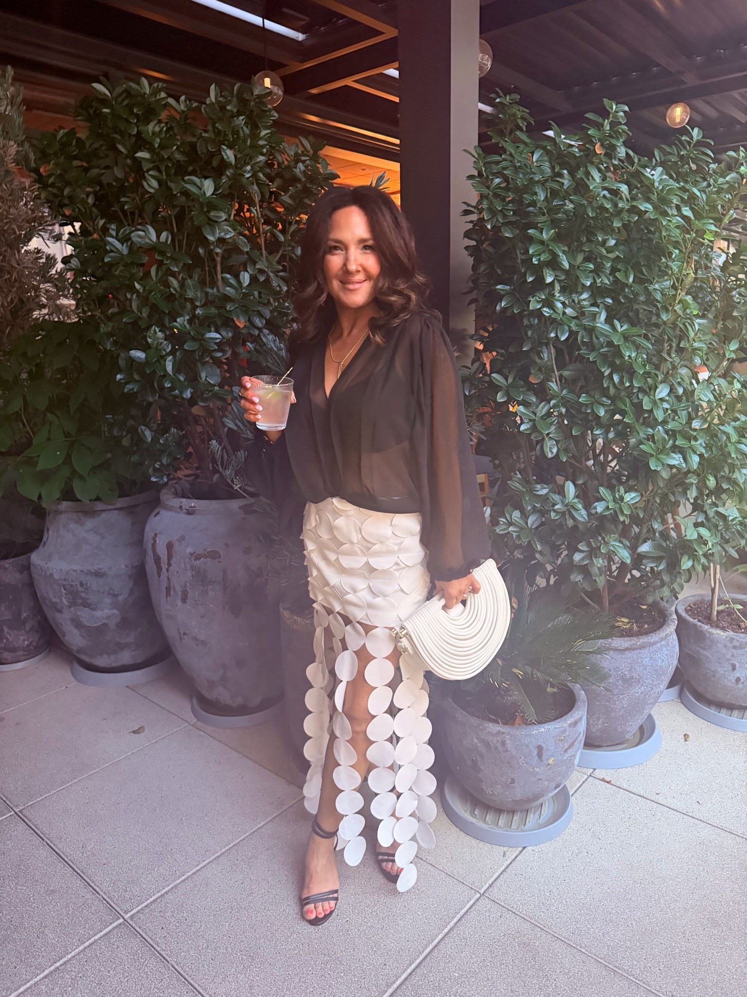 The perfect summer date night look This gorgeous flowy white skirt paired with a lightweight floaty sheer top and strappy heels is feminine effortless and so chic Perfect for dinner date night vacation or any summer night out

#LTKootd #LTKPetite #LTKOver40