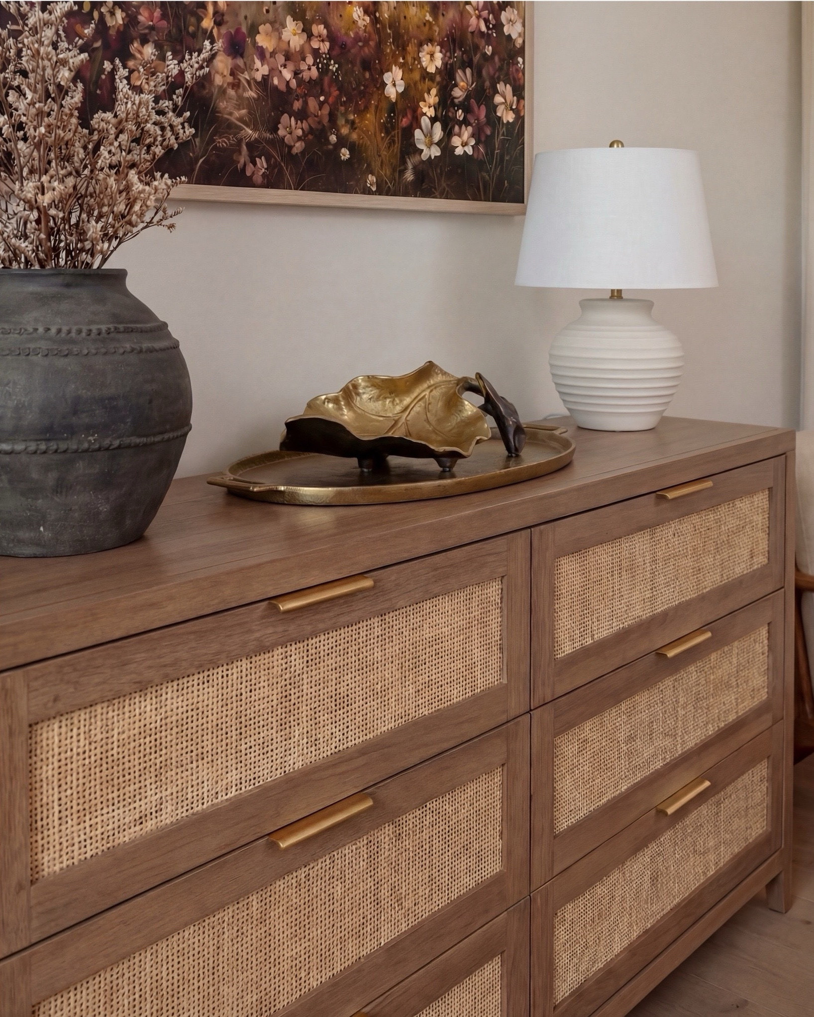 Shop the Look:
• Wood Woven rattan bed frame
• White upholstered mattress or box spring
• Black wood 3-drawer nightstands (set of 2)
• White duvet cover (hotel-style)
• White fitted sheet + pillow set
• Chunky knit throw blanket (beige or oatmeal)
• Neutral patterned accent pillow
• Brass globe wall sconces
• Cream ceramic table lamp with beige shade
• Large abstract landscape wall art (neutral tones)
•brown floral wall art
• Gold irregular curved scalloped wall mirrors
• Round woven knit poufs
• Neutral geometric or diamond area rug
• Large white ceramic vase
• Small decorative bowl (white or stone)
• Ivory linen curtain panels
•wood upholstered accent chair 
•black terracotta vase
•wood rattan dresser
•brass decor tray
•black leaf decor bowl 
•decor books

#LTKsale #LTKhome #LTKstyletip