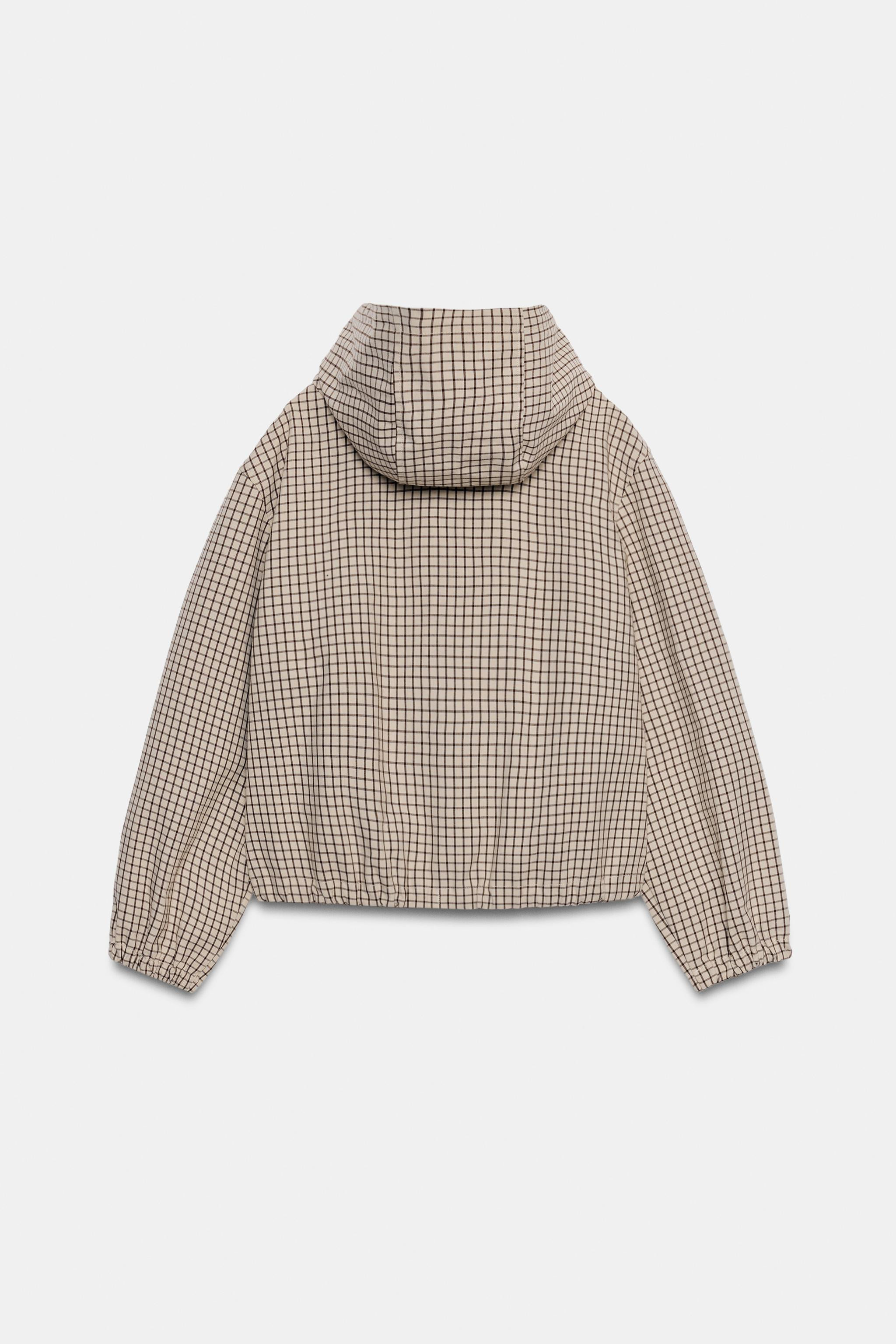 Jacket featuring an adjustable drawstring hood and long sleeves with elastic cuffs. Front double-... | Zara UK