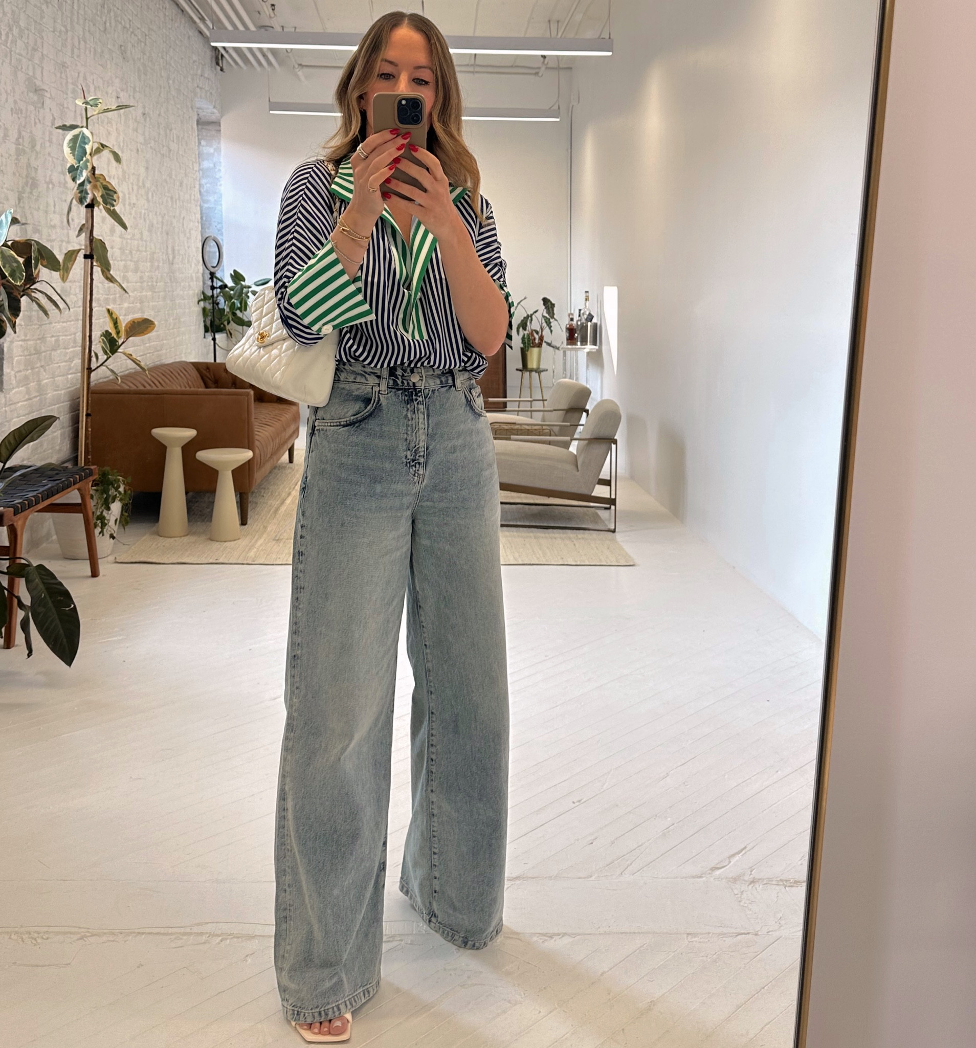 I am wearing a size small in the top. It runs a little large. The quality and feel of it is so nice!  These jeans are a recent fav that are so flattering. They are long and I do wear them with a heel. In this case, wearing the Stuart Weitzman Playa sandal that are comfortable for a heel! They run TTS.