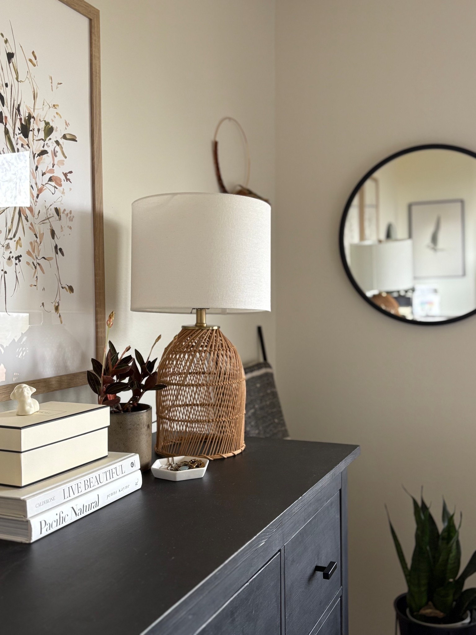 Bedroom dresser styling for warm cozy vibes. A mix of textures and contrast keep it dynamic. 🖤

Of the large floral artwork above the dresser and well basket lamp to soften out the straight lines of the black dresser .

#LTKHome