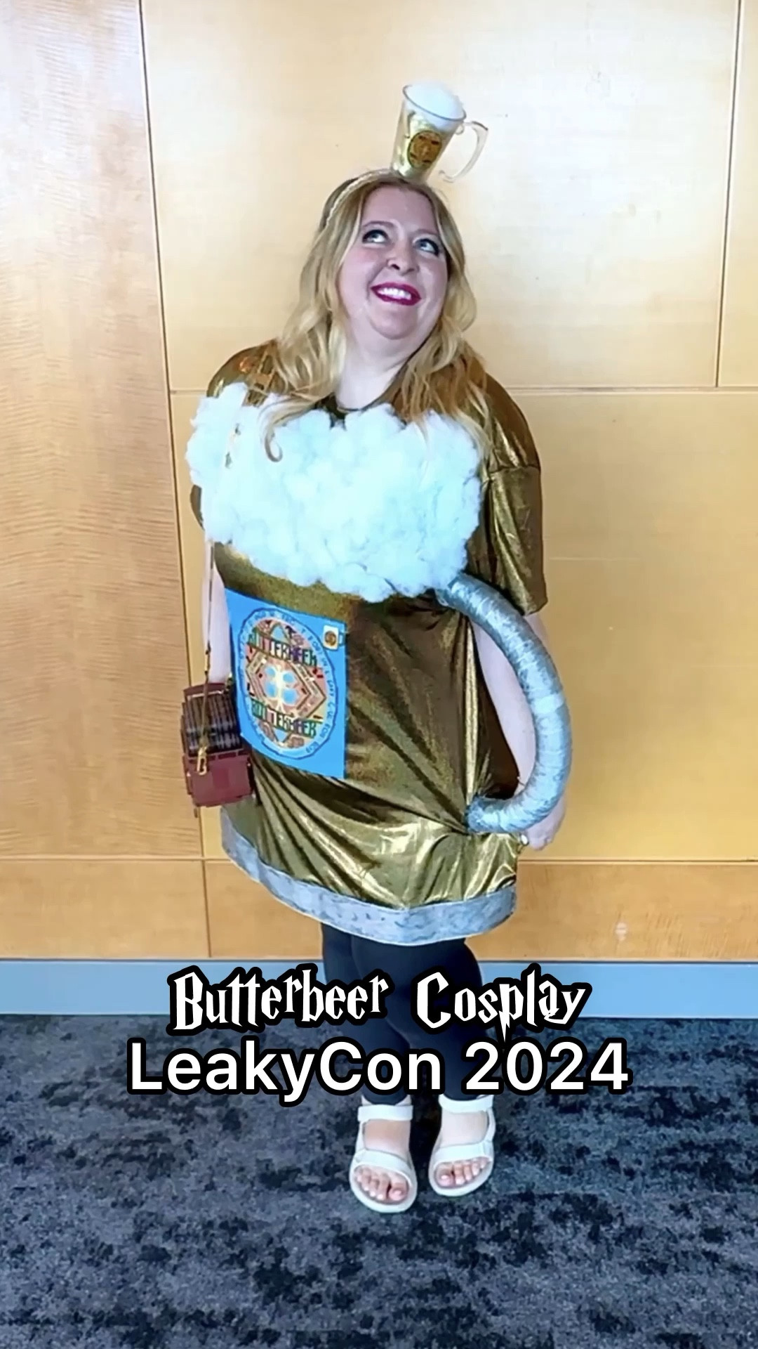 Butterbeer cosplay link to dress, shoes, and leggings. The handle was made with half a styrofoam wreath. Silver ribbon and polyfill were hot glued on. Find the purse at Universal! 