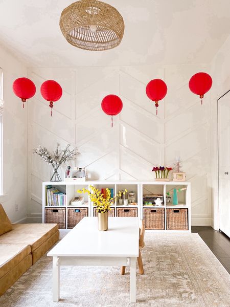 Lunar New Year decor with paper red lanterns! hanging pendants, brass vase, nylon string, clear decorating clips, Chinese new year decorations, craft table, wooden chairs, rug! 

#LTKSeasonal #LTKkids #LTKhome