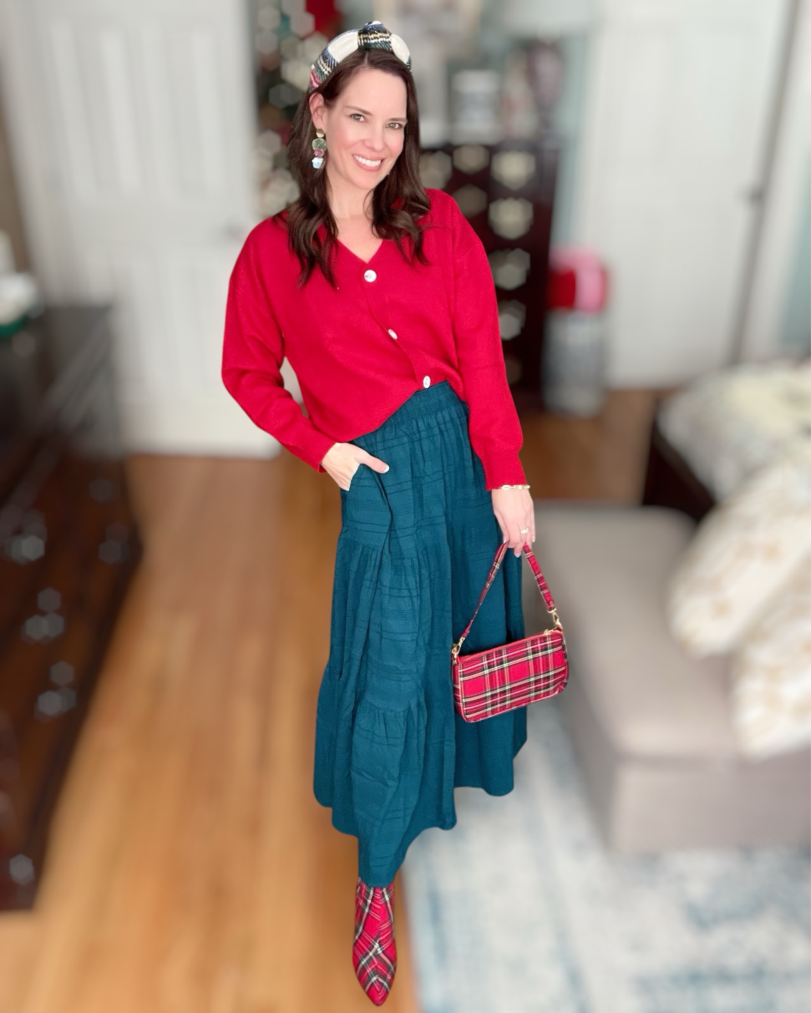 Okay this is my Christmas cupcake outfit and I am obsessed 🎀🎄 The bright red cardigan with the deep emerald skirt feels so classic holiday, but still easy and comfy enough to wear anywhere — classroom parties, church programs, Santa brunch, cookie swaps, or just living your best festive life at home 💚

I added this tartan padded headband which instantly makes the whole outfit look styled and intentional. And then we fully committed to the bit 😂 with the matching tartan bag and plaid boots — but in the cutest way, not the costume-y way. It ties everything together and brings that fun holiday sparkle without feeling over the top.

My boots are Betsy Johnson & earrings are from Cora’s Den, but I linked very similar tartan boot options + holiday statement earrings so you can recreate the look 💋✨

The whole outfit just feels happy. That’s the best word. Happy, festive, bold, and still wearable.

⸻

holiday outfit ideas christmas outfit inspo festive accessories tartan holiday look red and green outfit plaid boots christmas party outfit cozy holiday style bright christmas colors millennial mom style classic feminine holiday outfit merry & bright wardrobe 🎄✨💋

#LTKHoliday #LTKItBag #LTKShoeCrush