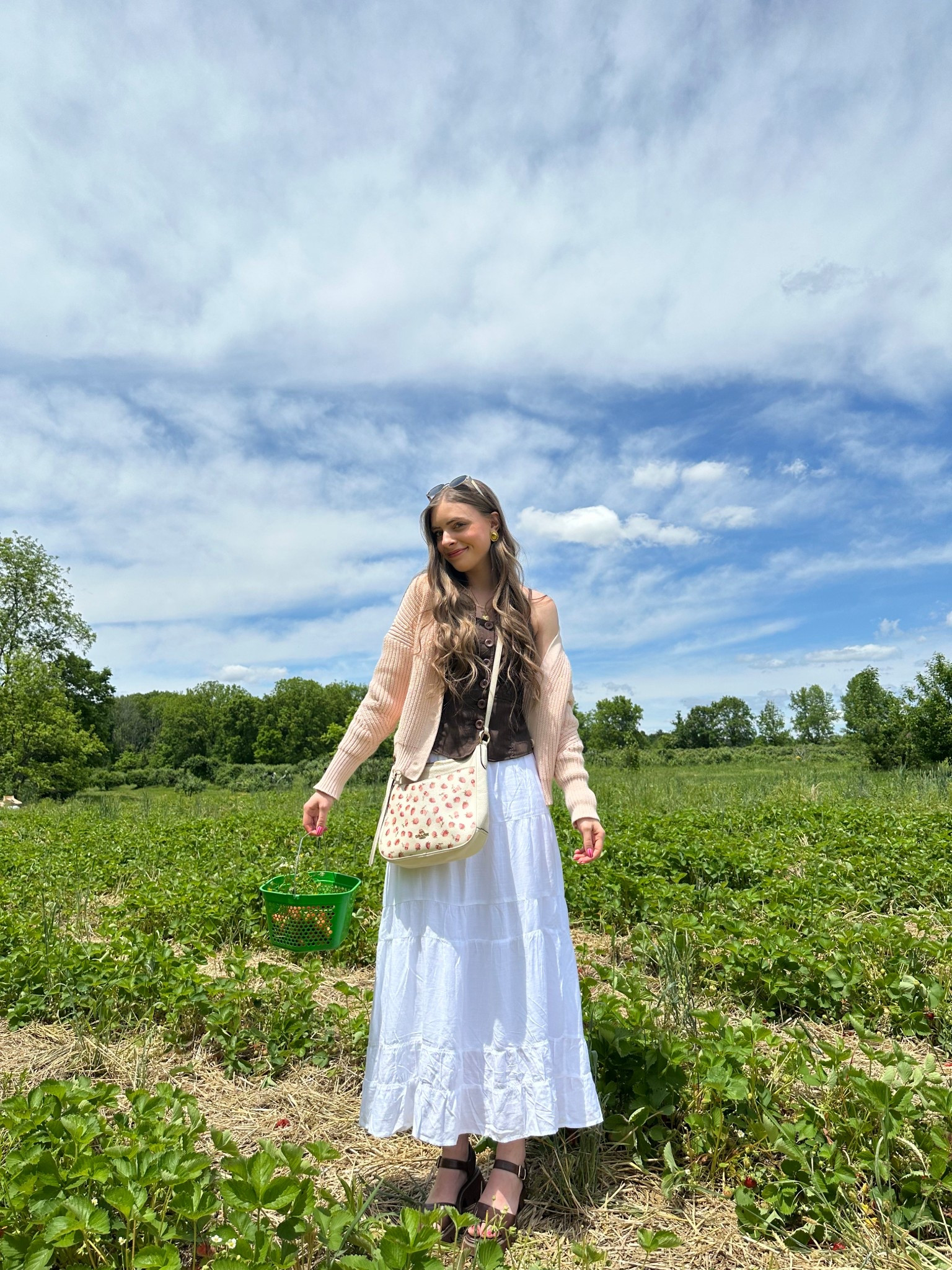 OOTD 5/24/25

My cutie outfit today for strawberry picking! My cardigan is thrifted Point Sur (J. crew), my tank is thrifted Zoompy Paris and my bag is thrifted Coach. Everything else is new and linked exact!

Dark brown button front tank y2k thrifted early 2000s style vest top, light baby pink cable knit cropped cardigan sweater, crossbody coach hobo strawberry raspberry cherry fruit print bag, white linen maxi skirt outfit ideas, strawberry picking date idea outfits, casual spring summer beachy outfit inspo, dark brown leather chunky sandals, strappy platform lug sole flatform sandals, gold jewelry stack, vintage gold button earrings, tall girl fashion, new hollister finds, hollister sale 

#LTKStyleTip #LTKSummerEdit #LTKSaleAlert