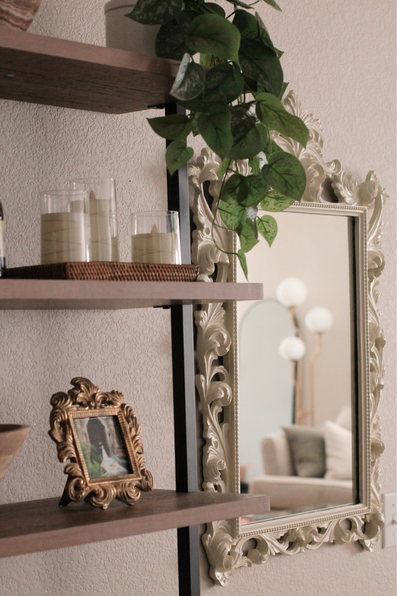 My organic modern living room wall, decorated with a tall shelf holding twinkle candles and a picture frame, hanging plant, and cream ornate vintage mirror. 



#LTKHome #LTKFindsUnder50 #LTKFindsUnder100