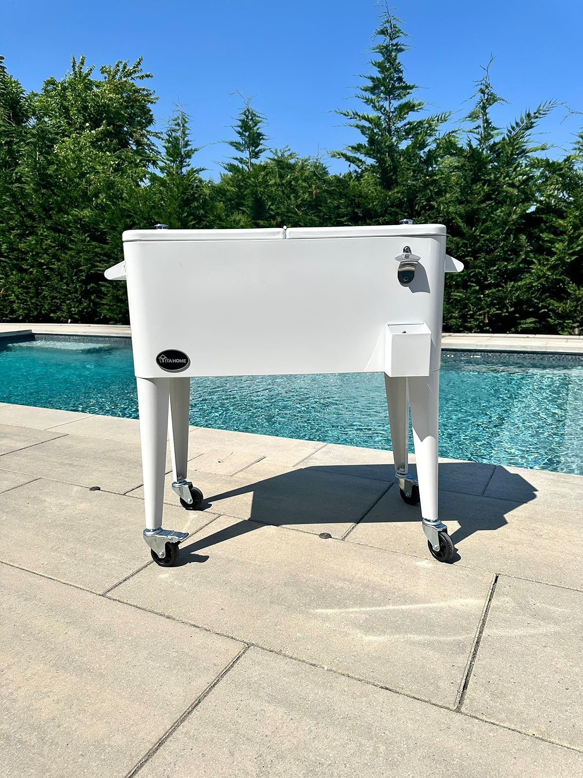 This 80 quart rolling cooler cart is the perfect addition to your patio this summer! The ultimate outdoor hosting accessory! The cover can be completely removed or just opened on one end or the other. It has a built in bottle opener with bottle cap bin, a water drainage hole and wheels for easy movement. | Amazon (US)