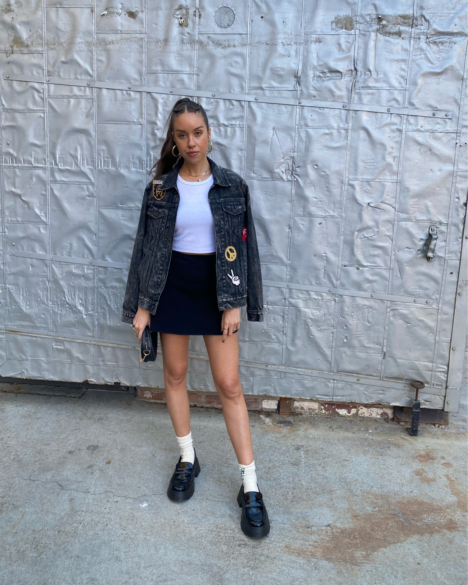 Styling a white crop top with a black mini skirt and denim patch jacket and black loafers

#LTKstyletip