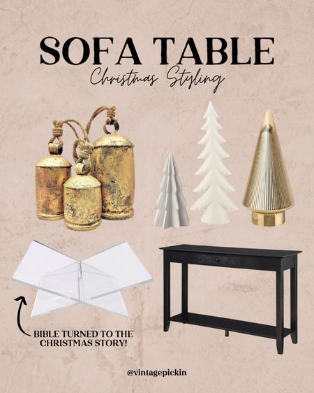 Simple Christmas styling on a sofa table! This is how I have my black sofa table behind my couch styled and I love the handmade large bells, book holder with the Christmas story and of course a tree collection! I may have an addiction 😂🤷🏻‍♀️ I love getting a new lil tree each year to style around the house. 

#LTKhome #LTKstyletip #LTKSeasonal