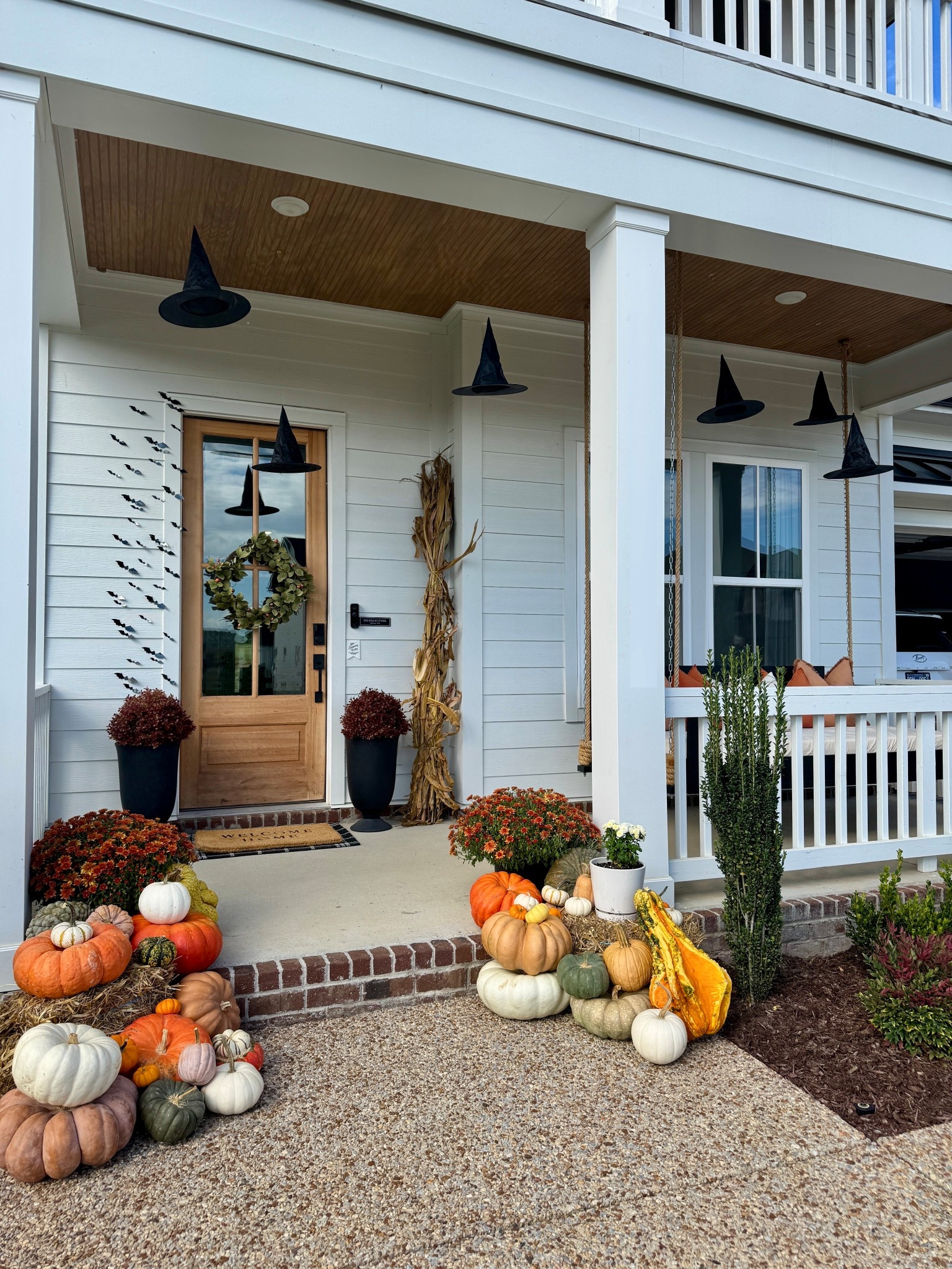 Who doesn’t love a decorated fall front porch? This set up is great because once Halloween is over, you can pack up all the black spooky decor and still be left with the perfect fall thanksgiving porch set up

Witch hats hanging, bats, pumpkins, corn stalk, outdoor fall porch, Halloween front porch, fall front porch, porch swing 

#LTKHome #LTKSeasonal #LTKHalloween