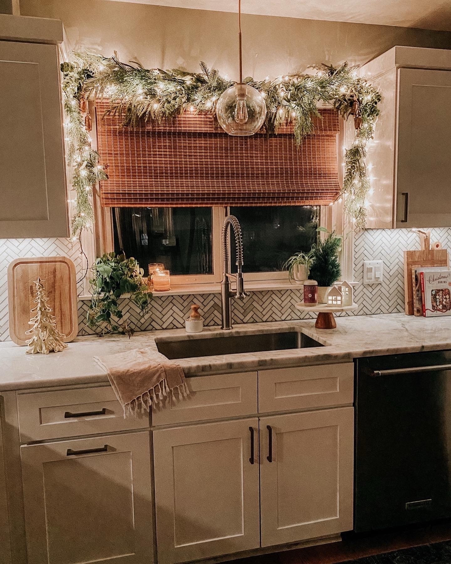 Cozy Christmas kitchen decor with Christmas garland and twinkle lights. My favorite place to put garland is over the kitchen window. And these are the bamboo shades I always get questions about  #garlanddecor #windowgarland #christmaskitchen #christmasgarland #bambooshade

#LTKHome #LTKHoliday #LTKSeasonal
