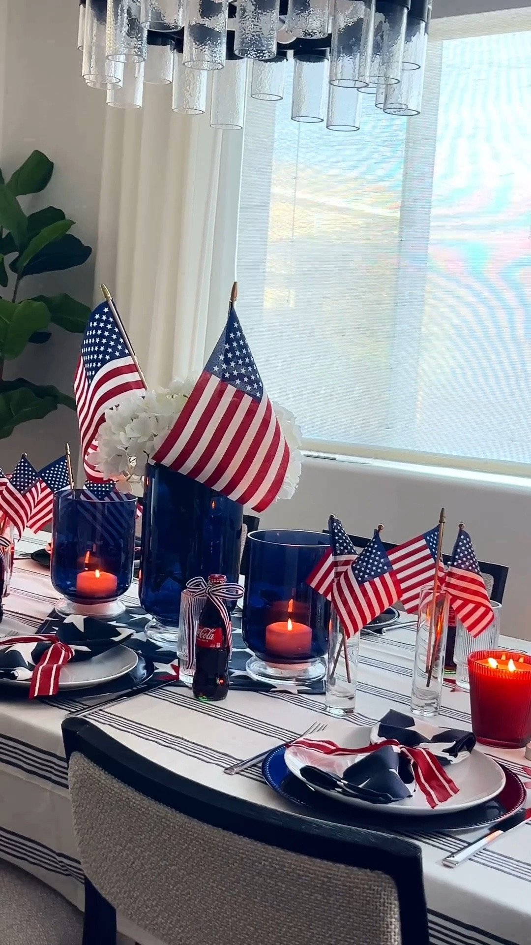 Americana table decor, patriotic tablescape, Memorial Day table setting, 4th of July table ideas, red white and blue decor, striped tablecloth, star napkins, patriotic napkin rings, navy blue plates, white dinner plates, layered table setting, ribbed drinking glasses, blue glass vases, hydrangea centerpiece, American flags table decor, mini flags centerpiece, red candle holders, taper candles neutral holder, coke glass bottles vintage style, ribbon tied bottles, patriotic cake stand, hosting table ideas, summer hosting decor, classic Americana style, modern patriotic table

#LTKHome #LTKSeasonal #LTKfoodie
